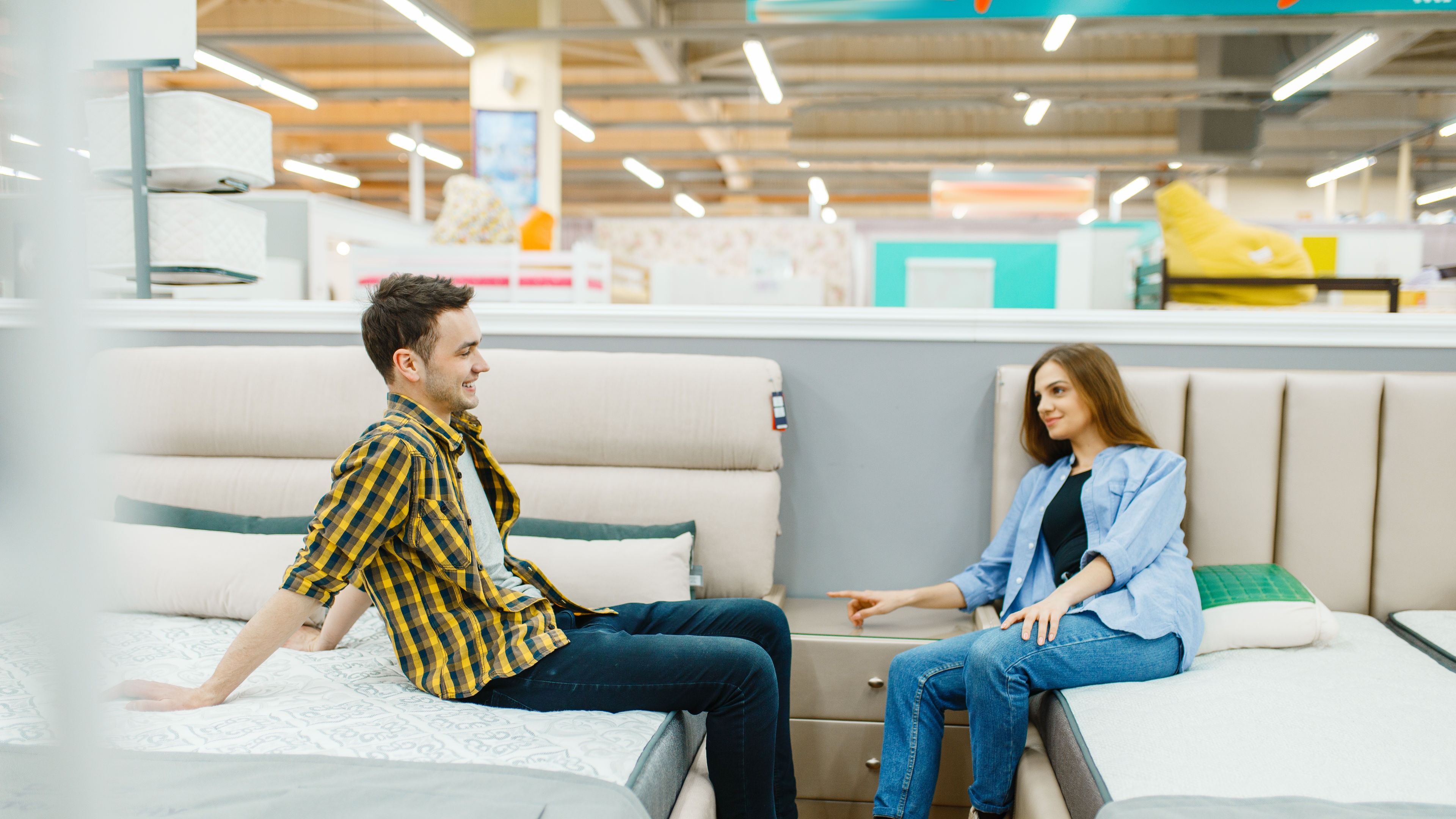 Couple Shopping for New Mattress in Store