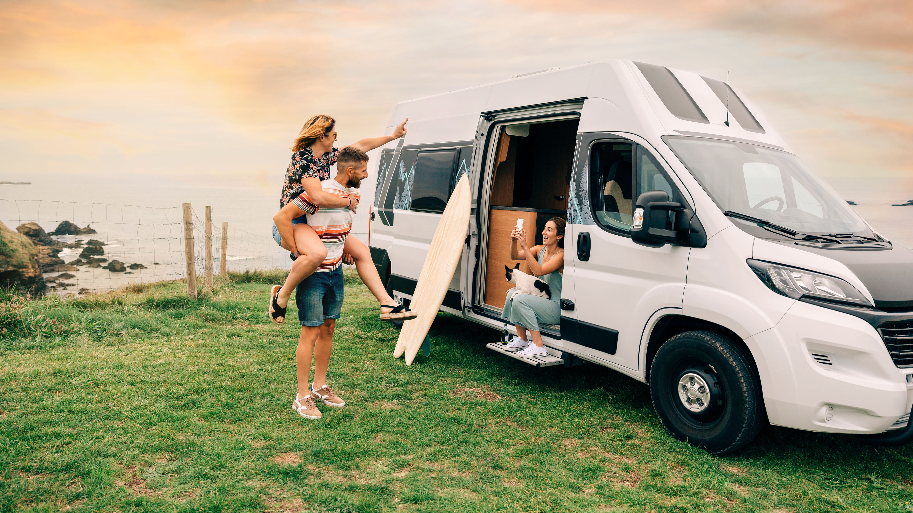 Friends travelling in a camper van, taking photos and enjoying the moment.
