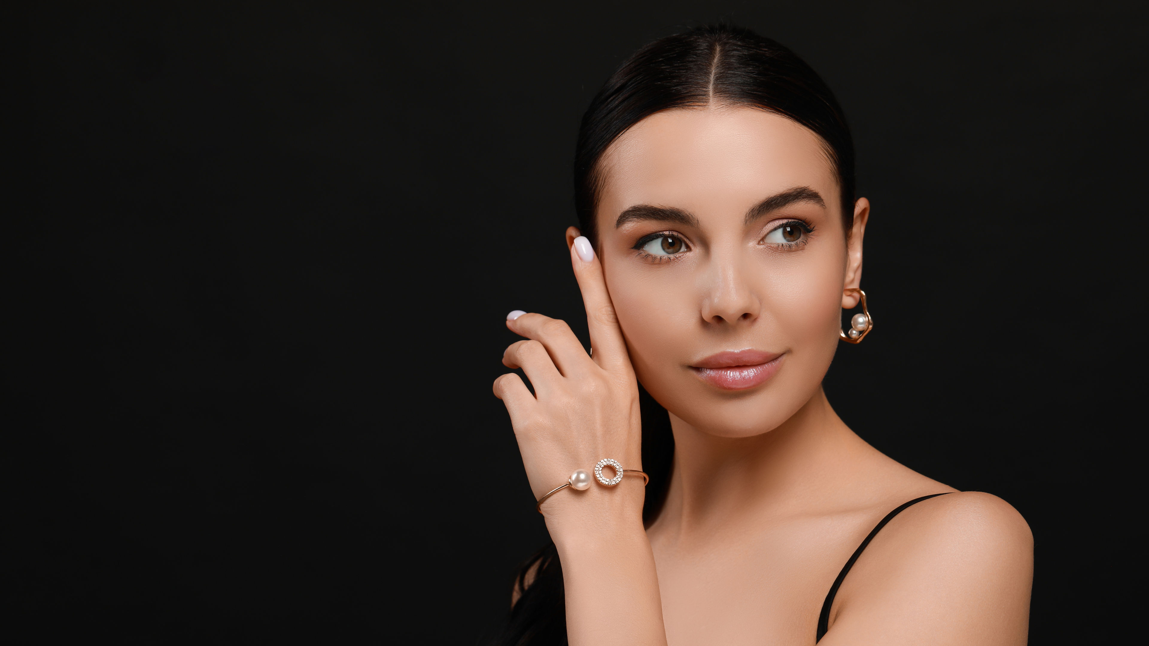 A beautiful woman in black dress wearing bracelet