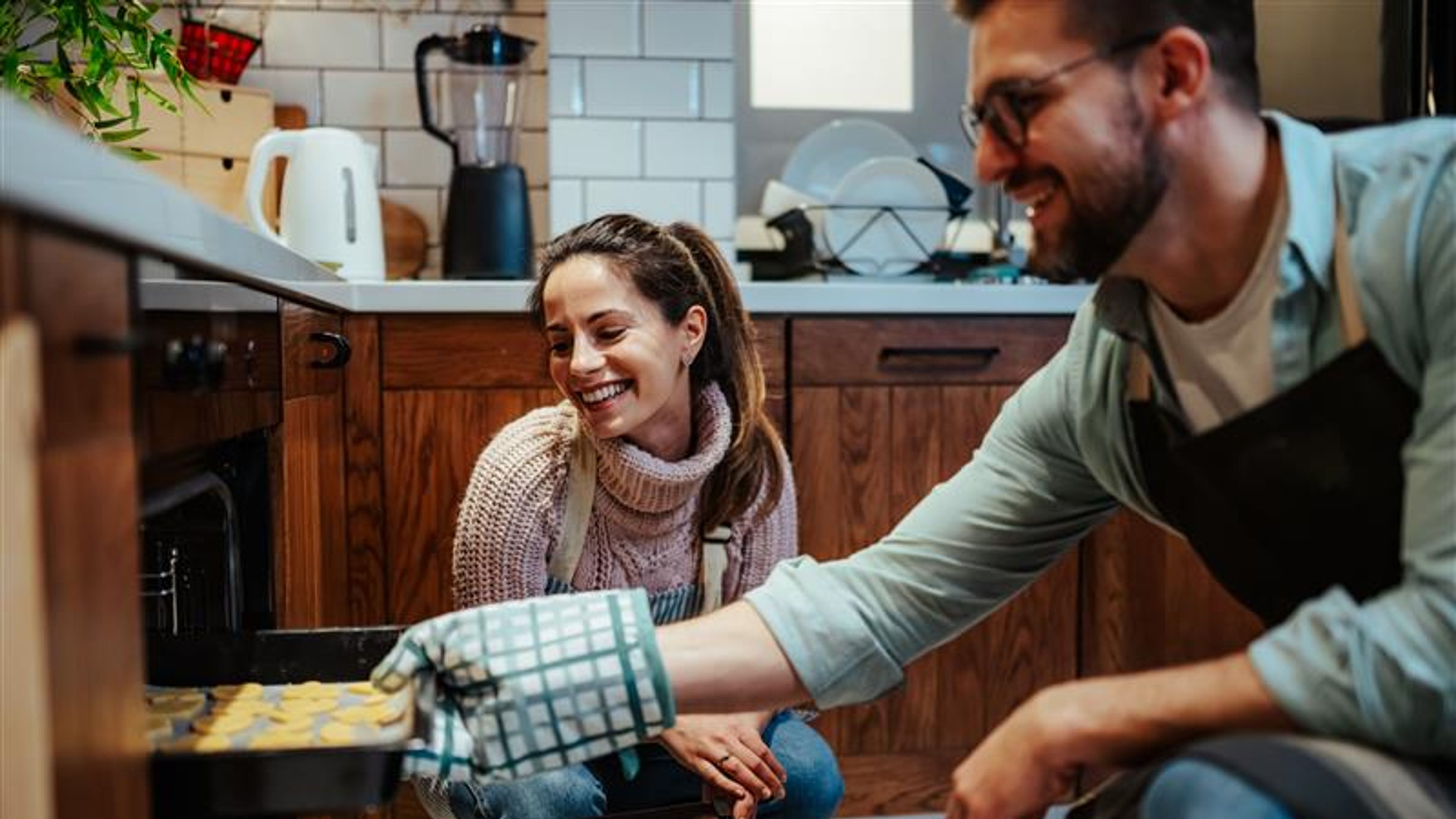 A couple baking together.