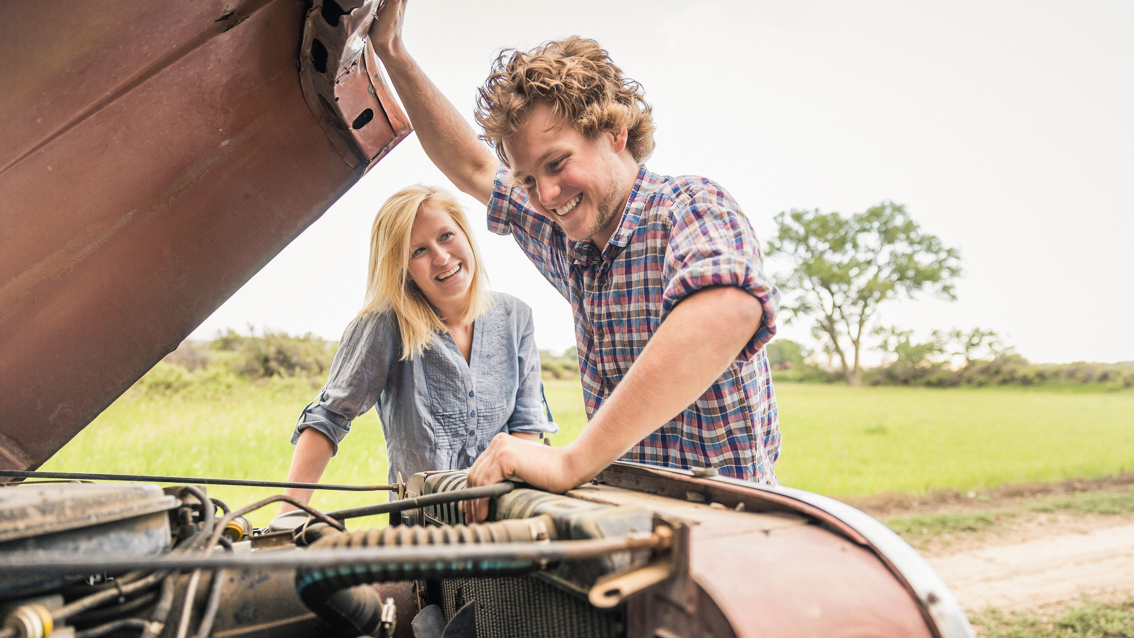 A couple checking a car