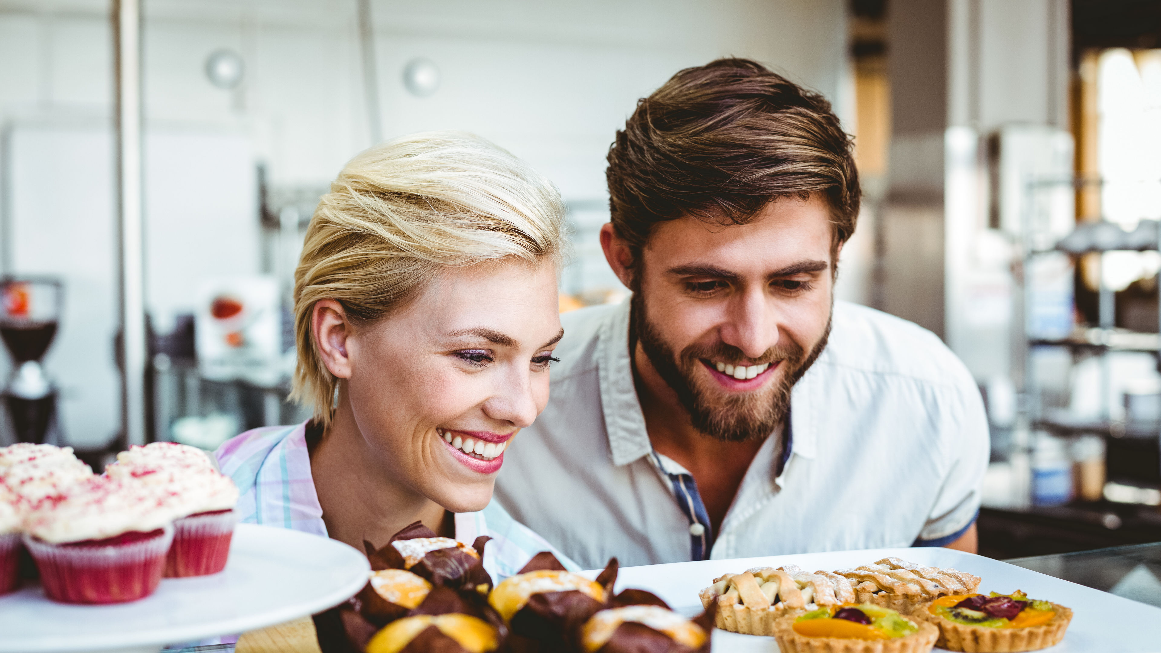 A couple looking at some cakes
