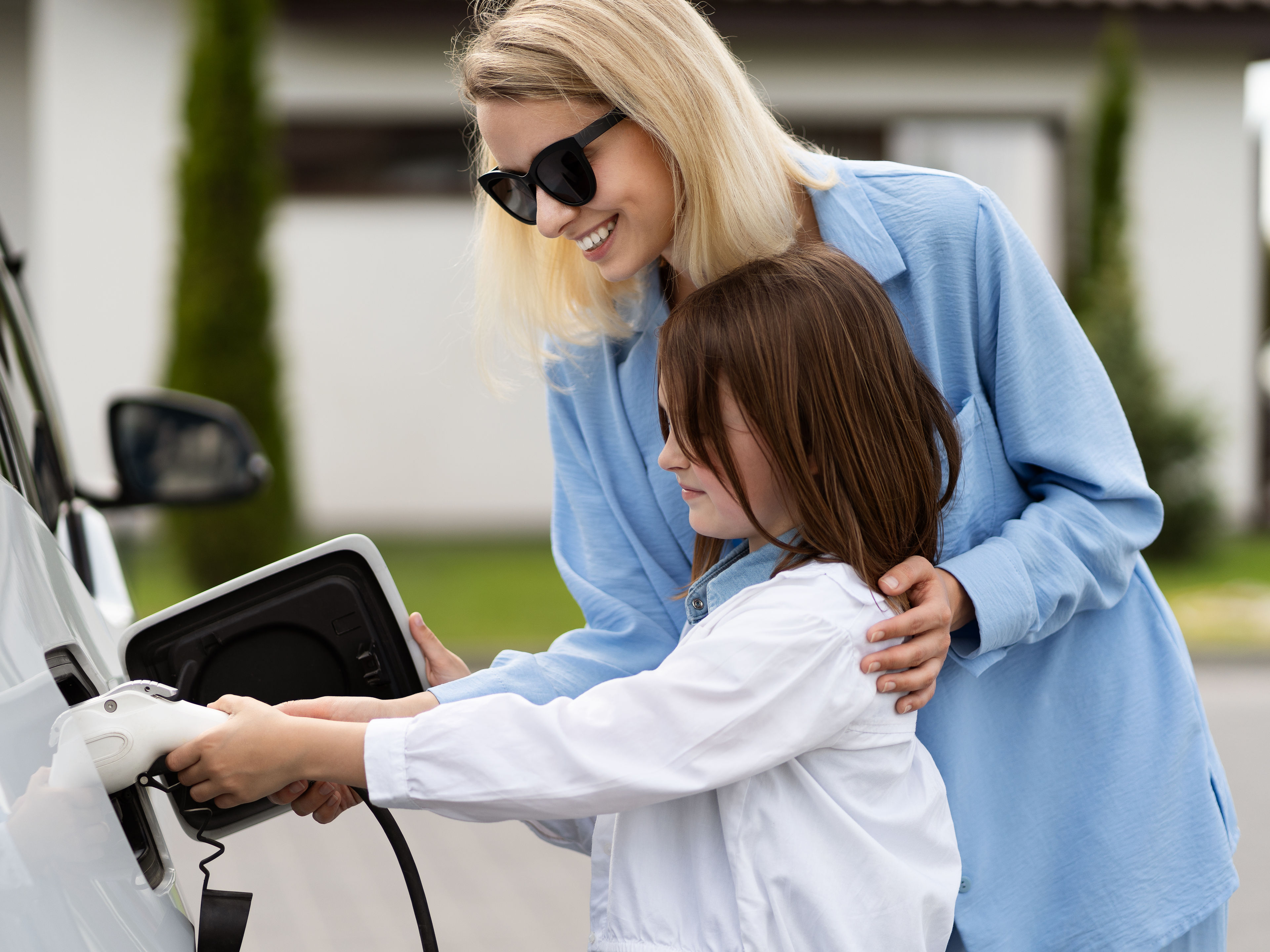 A family charging a car 
