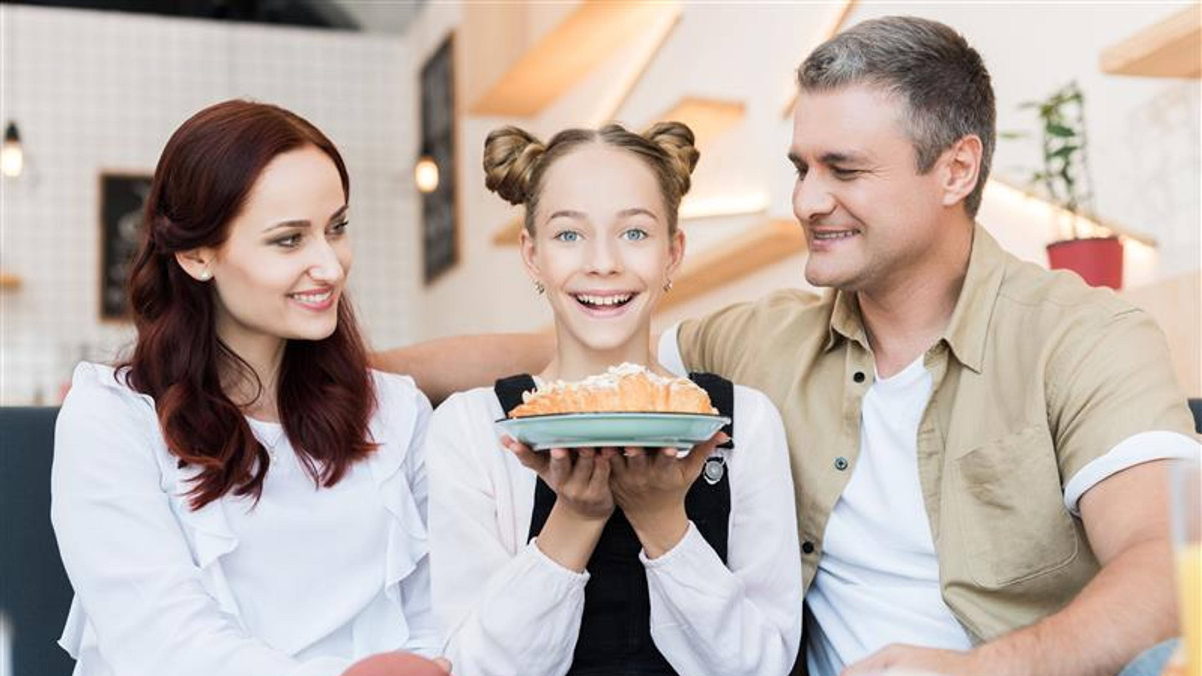 A family with a dessert in hand