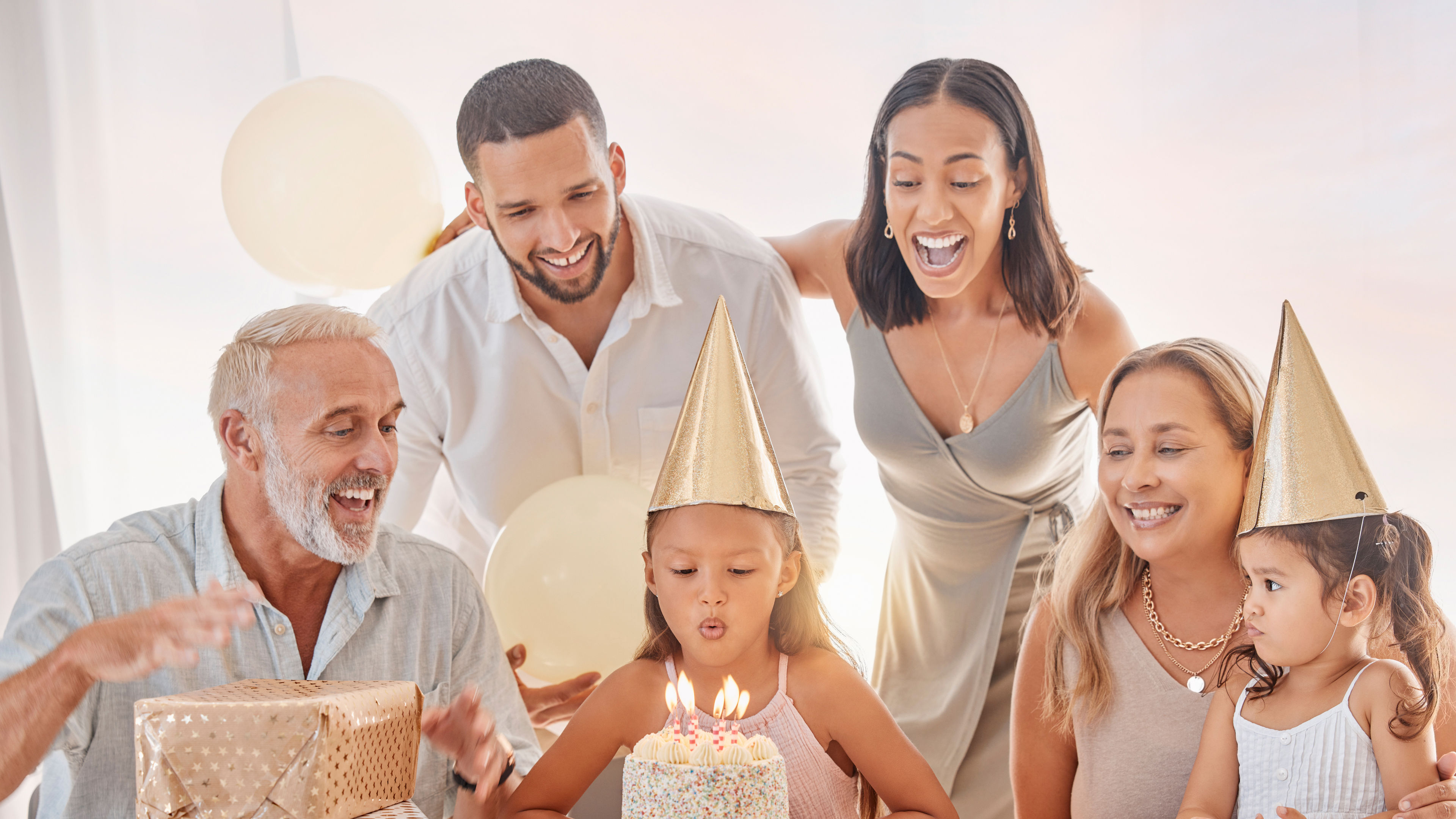 A happy family celebrates a young girl's birthday
