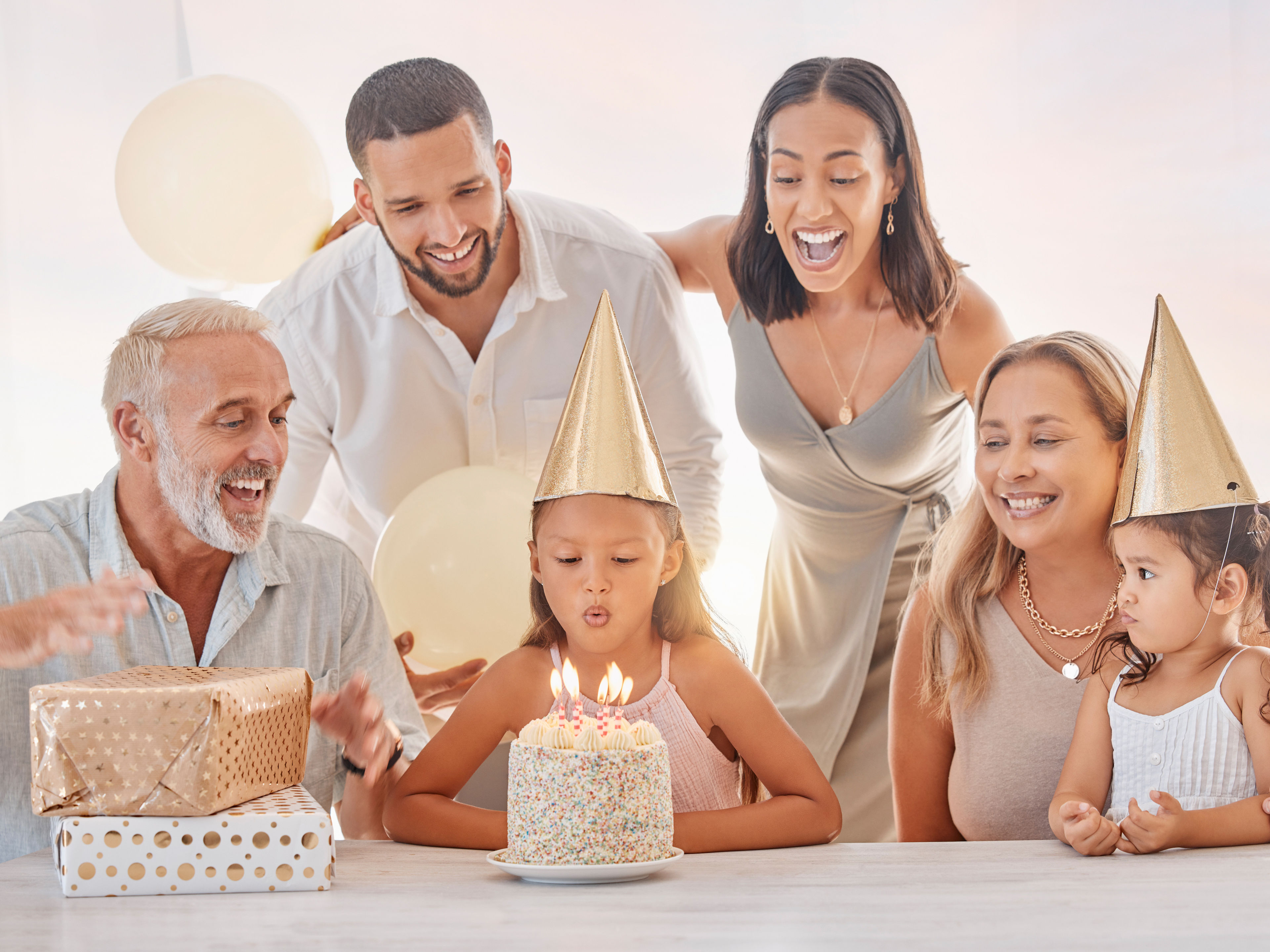 A happy family celebrates a young girl's birthday