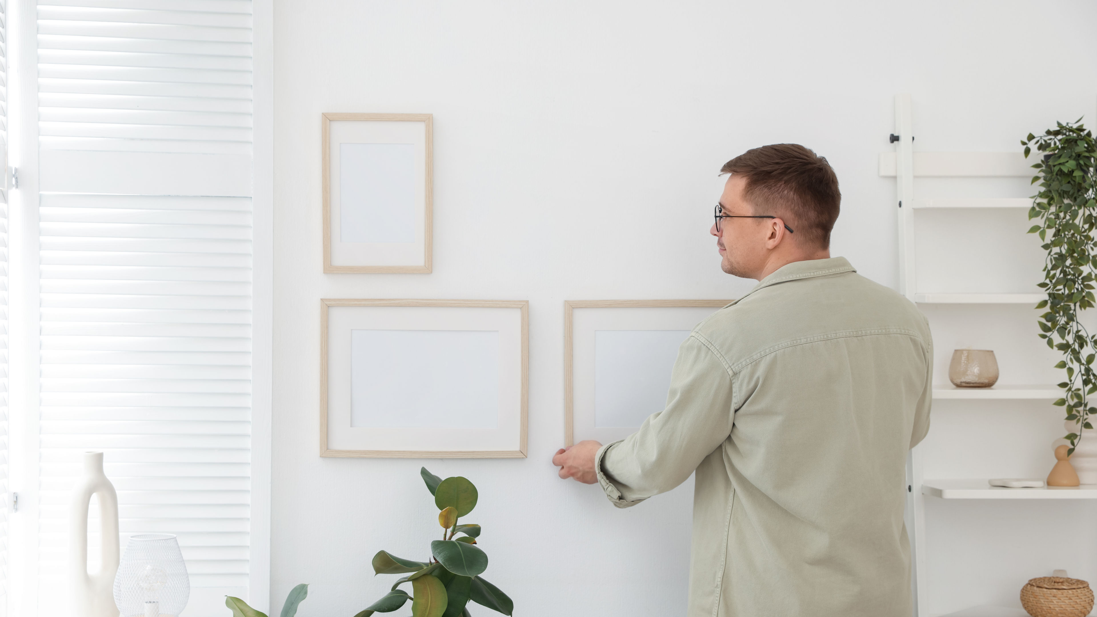 A man decorating the wall