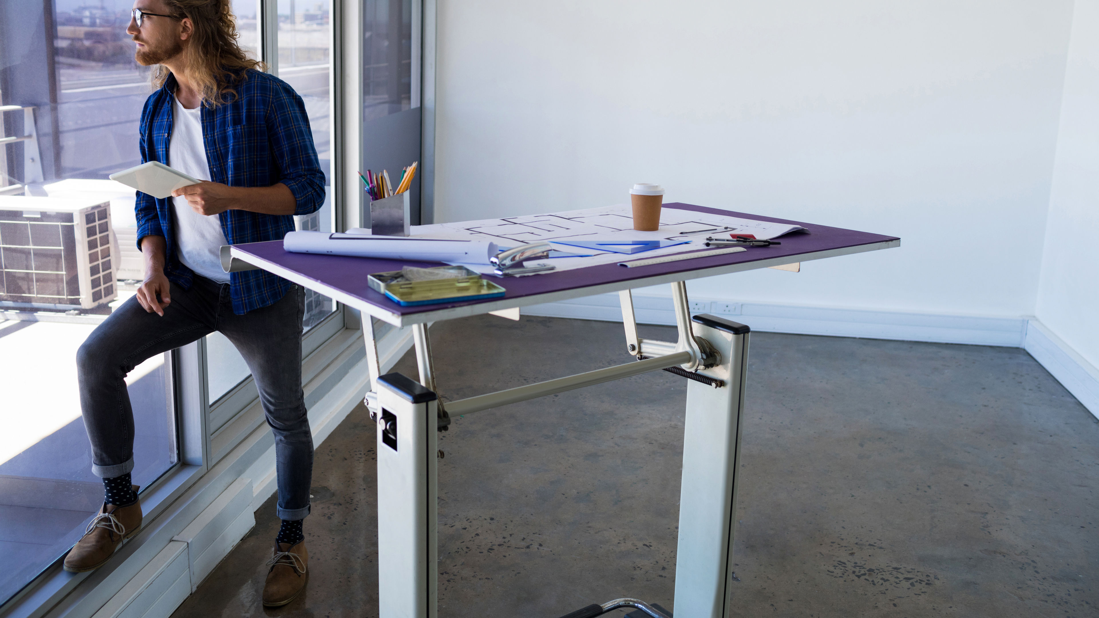 A man standing near to the table