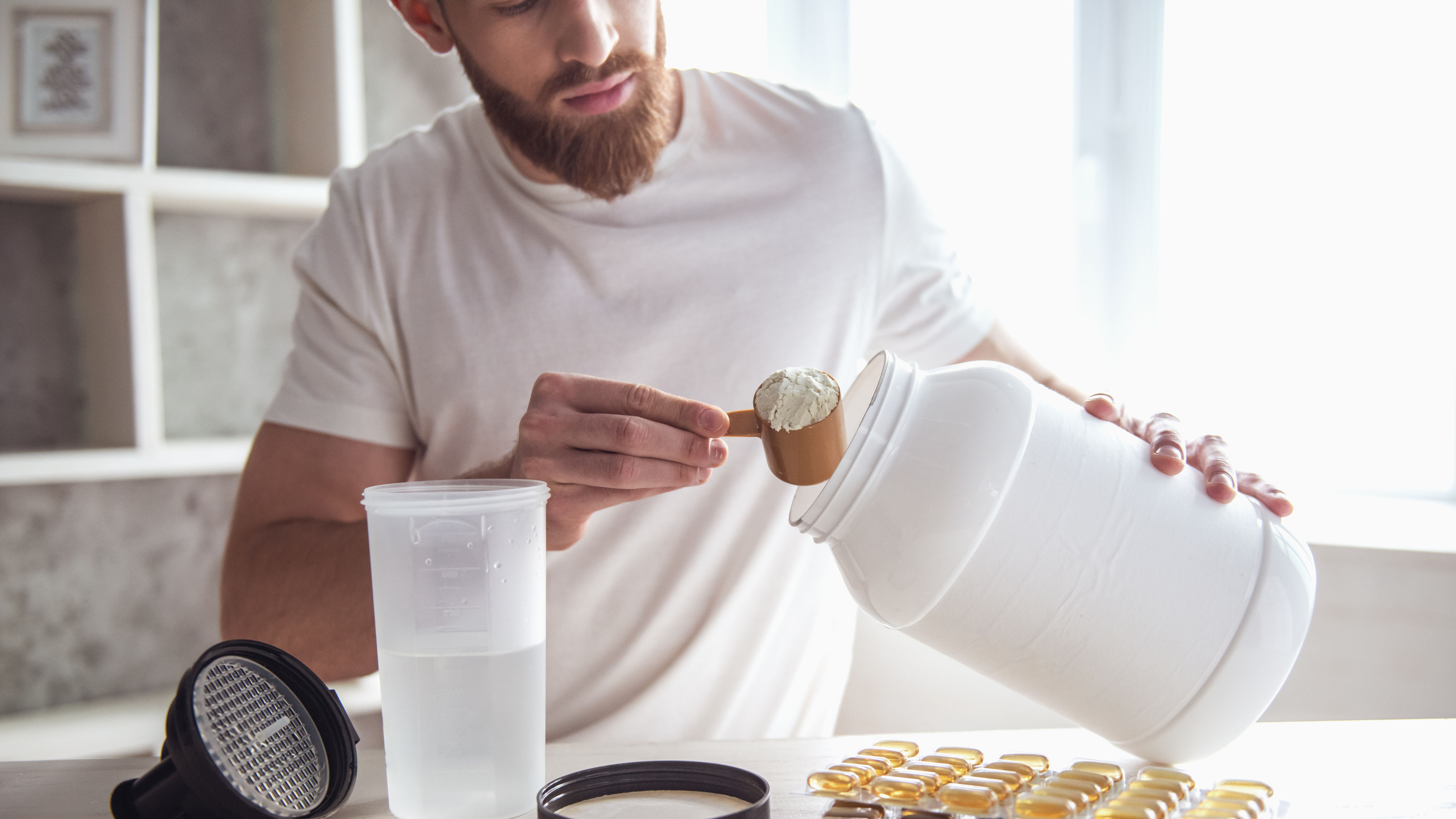 A man taking supplement powder