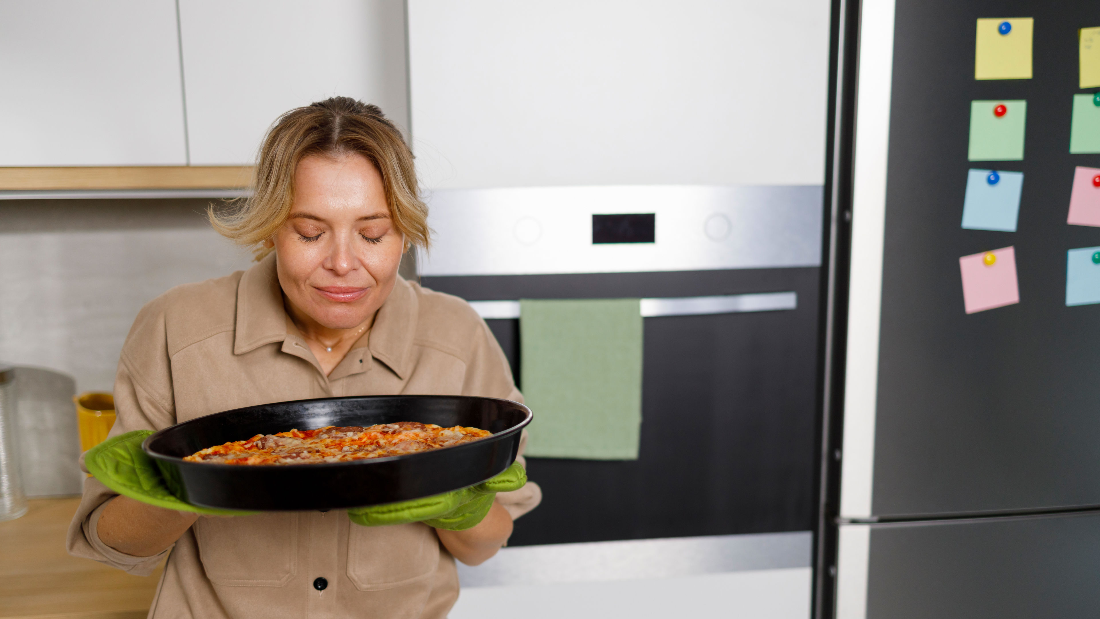 A woman enjoying the pizza.
