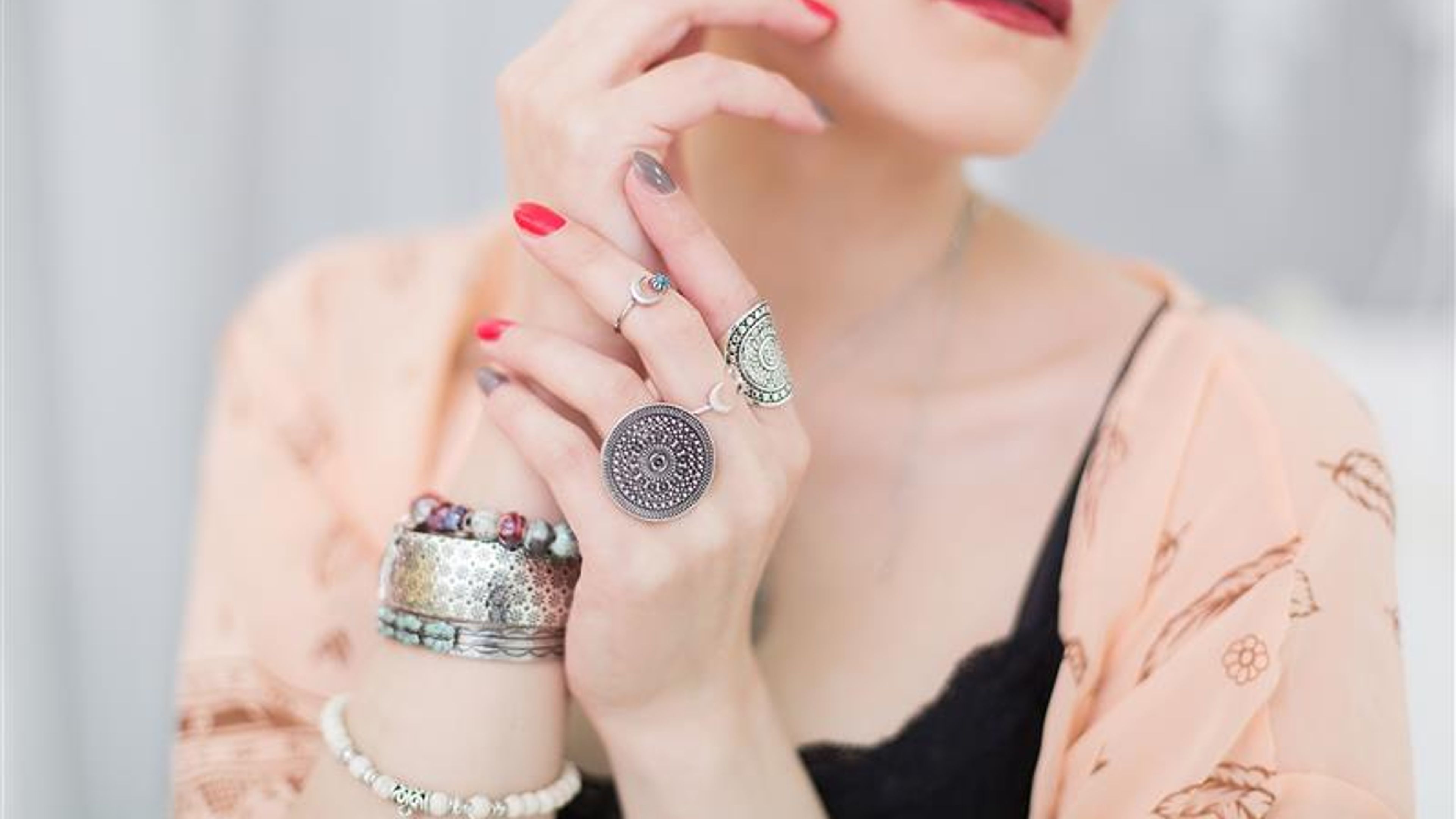 A woman’s hand with jewellery pieces. 