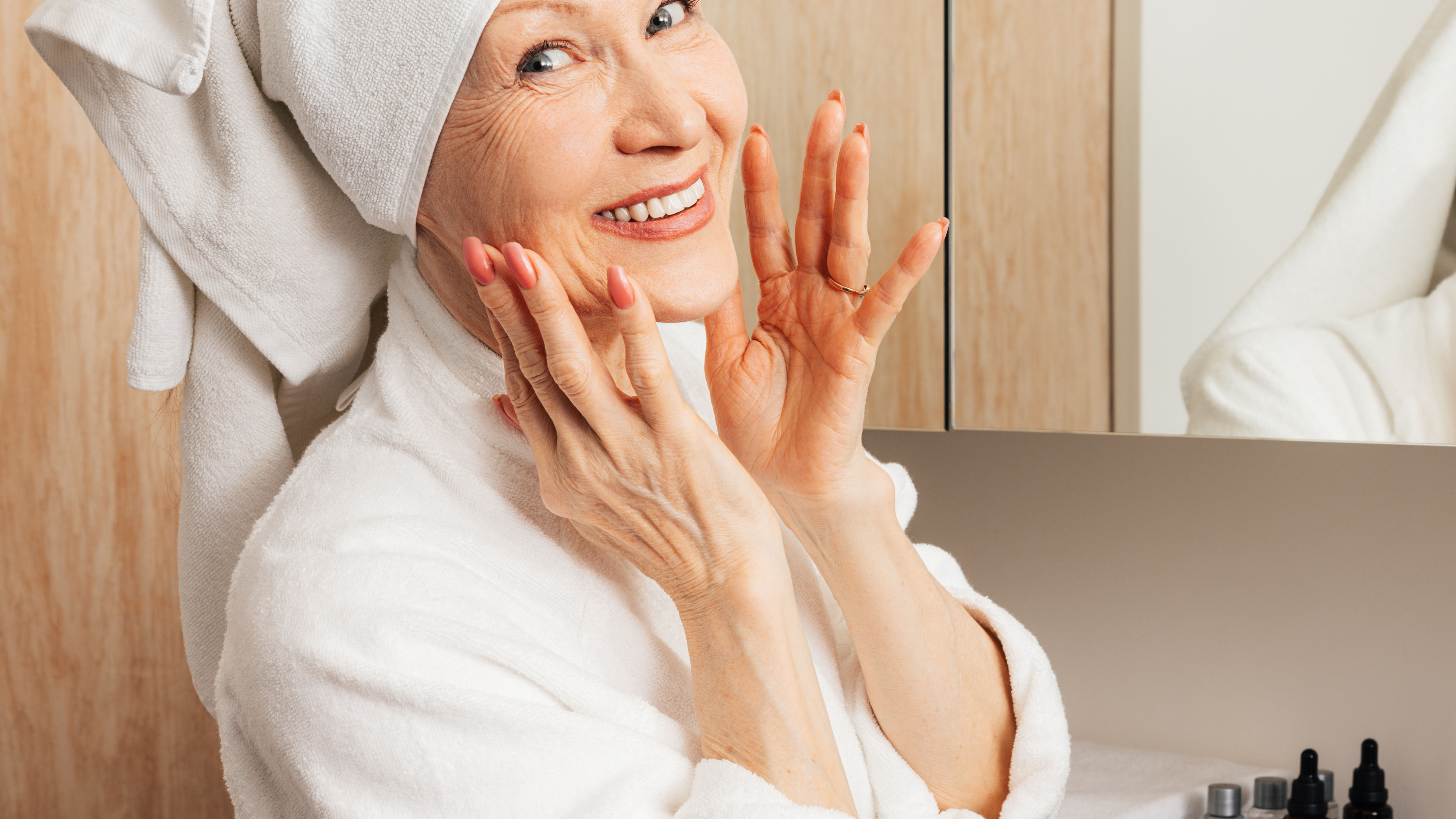 A woman happily doing her daily skin routine