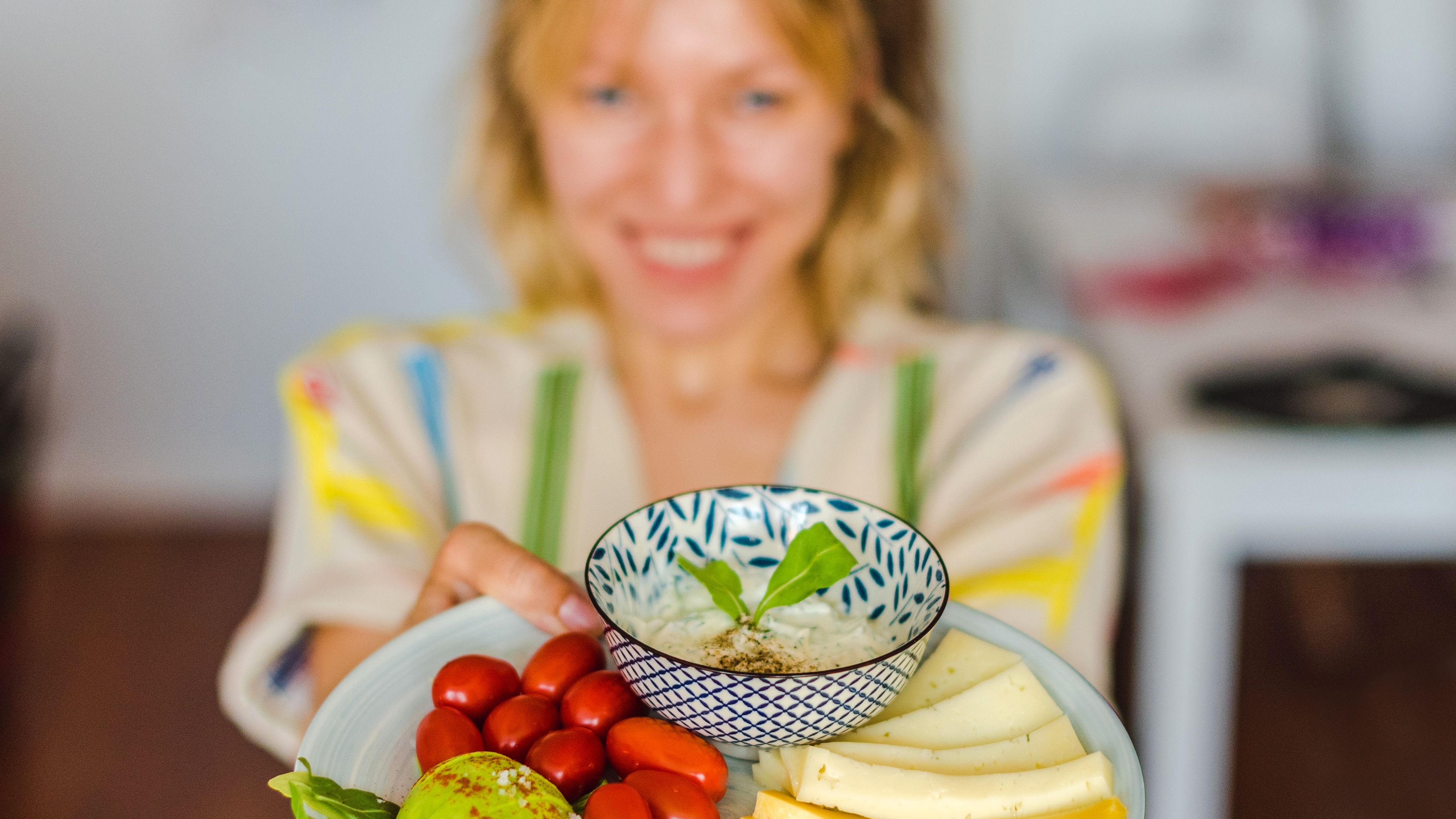 A Woman holding a plate of healthy food