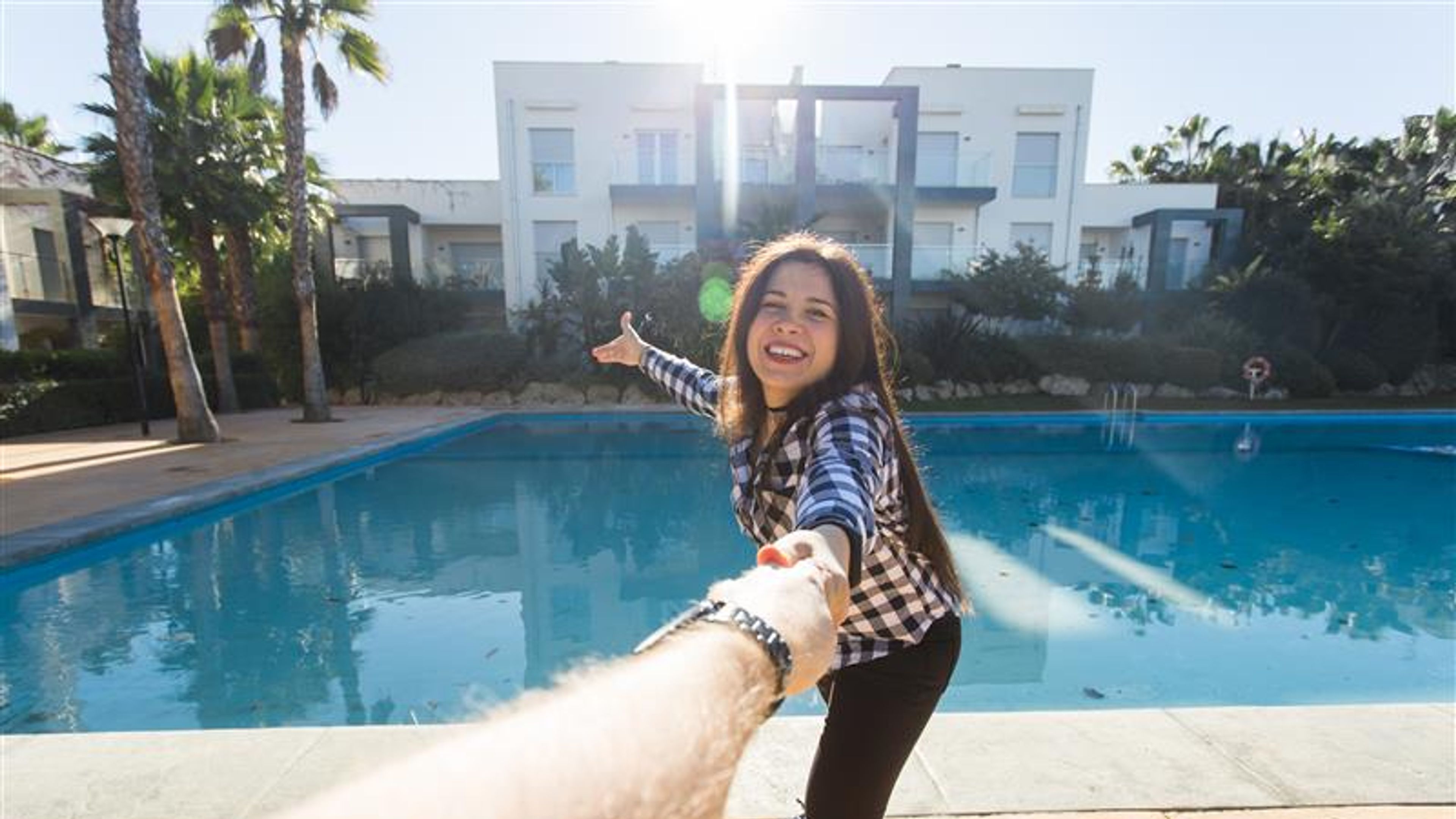 A woman holding hand and enjoying near pool