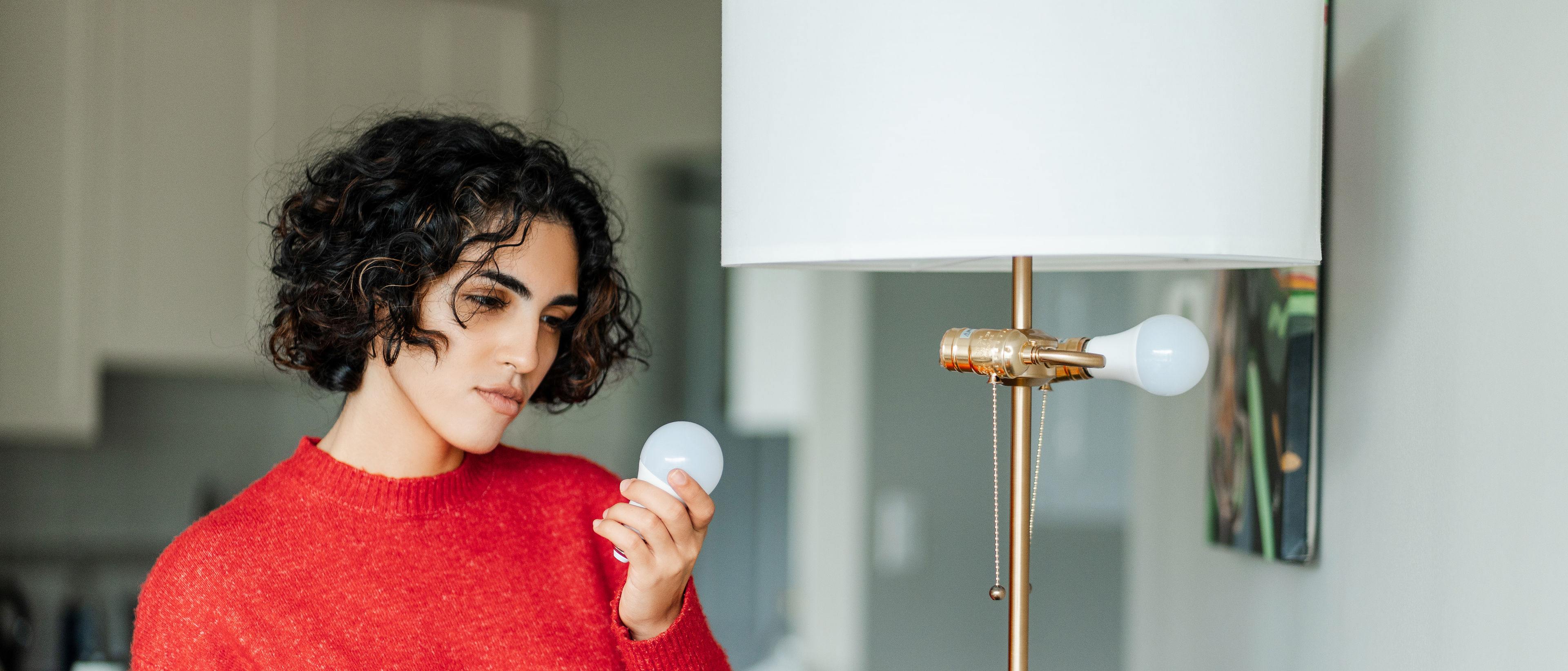 A woman looking at a bulb 