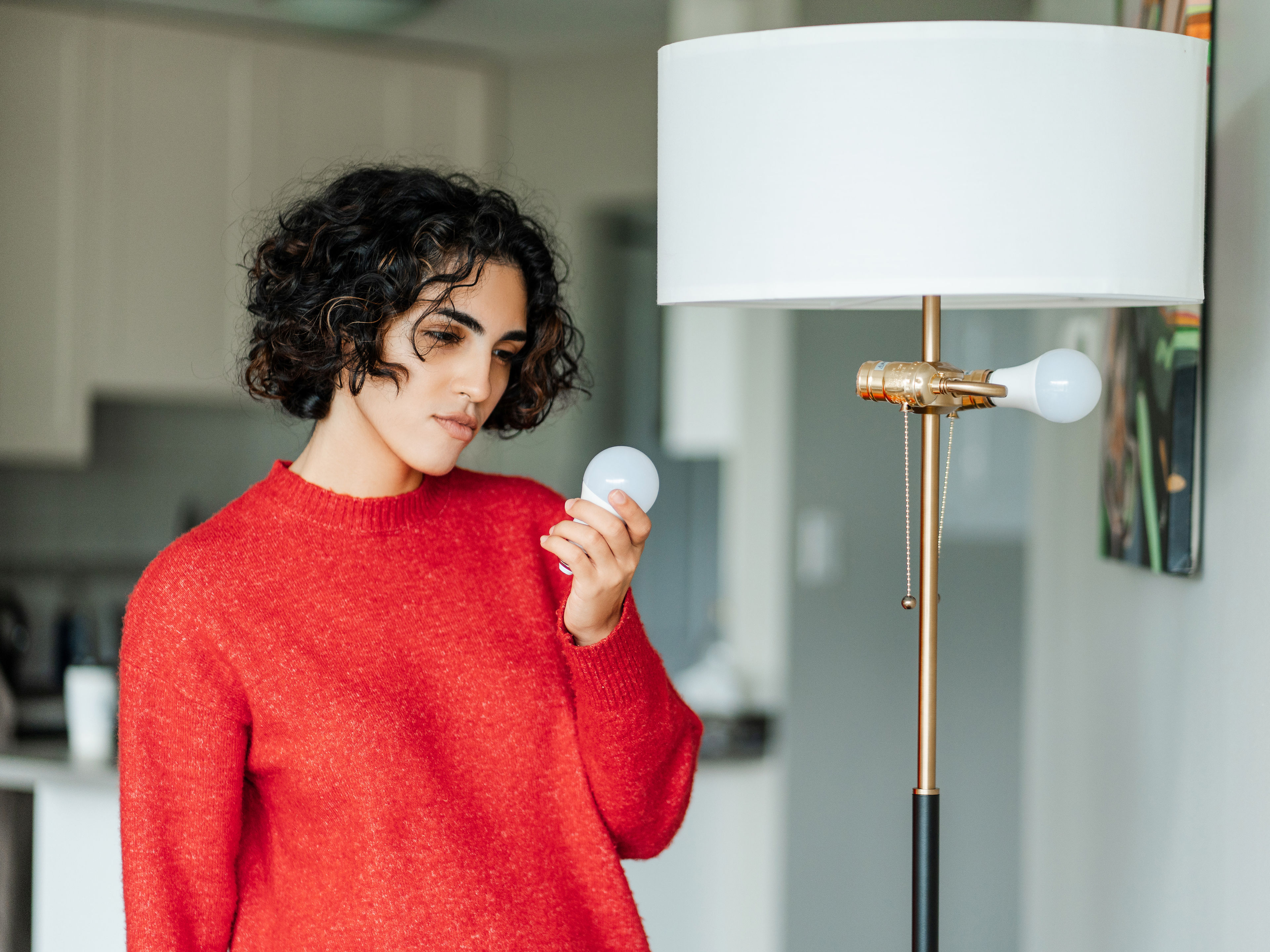 A woman looking at a bulb 