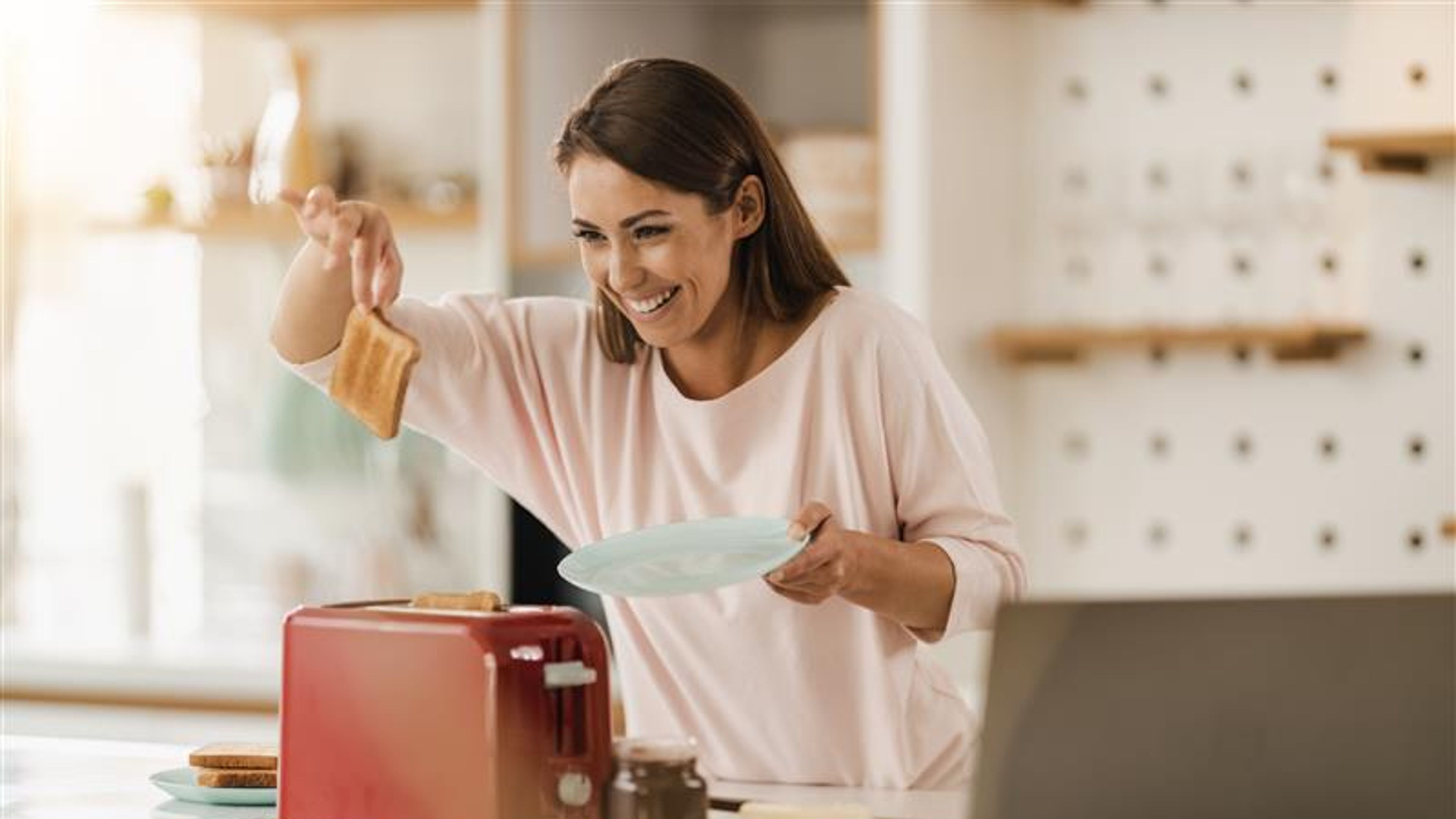 A woman toasting bread.