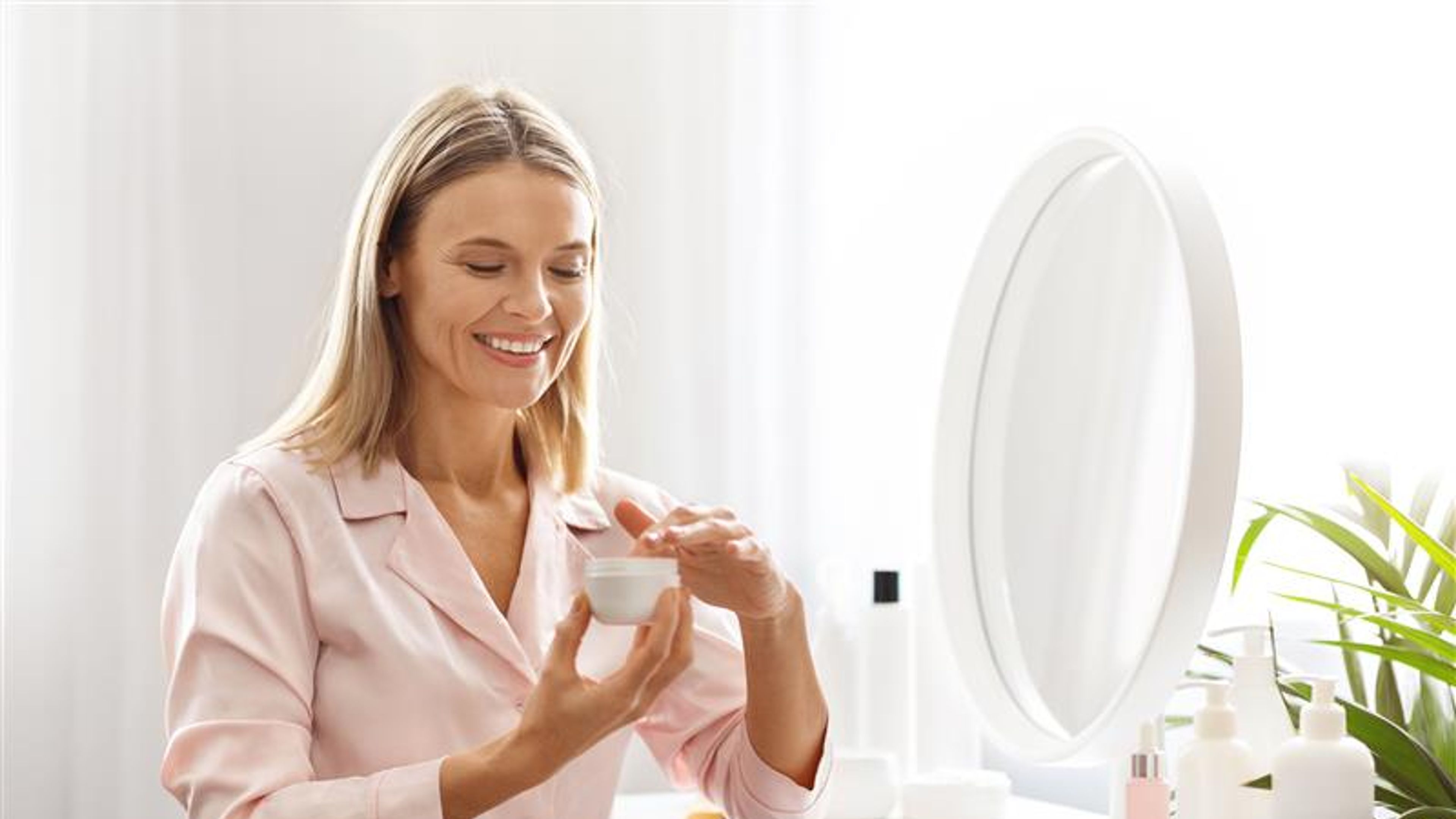 A woman using some face cream
