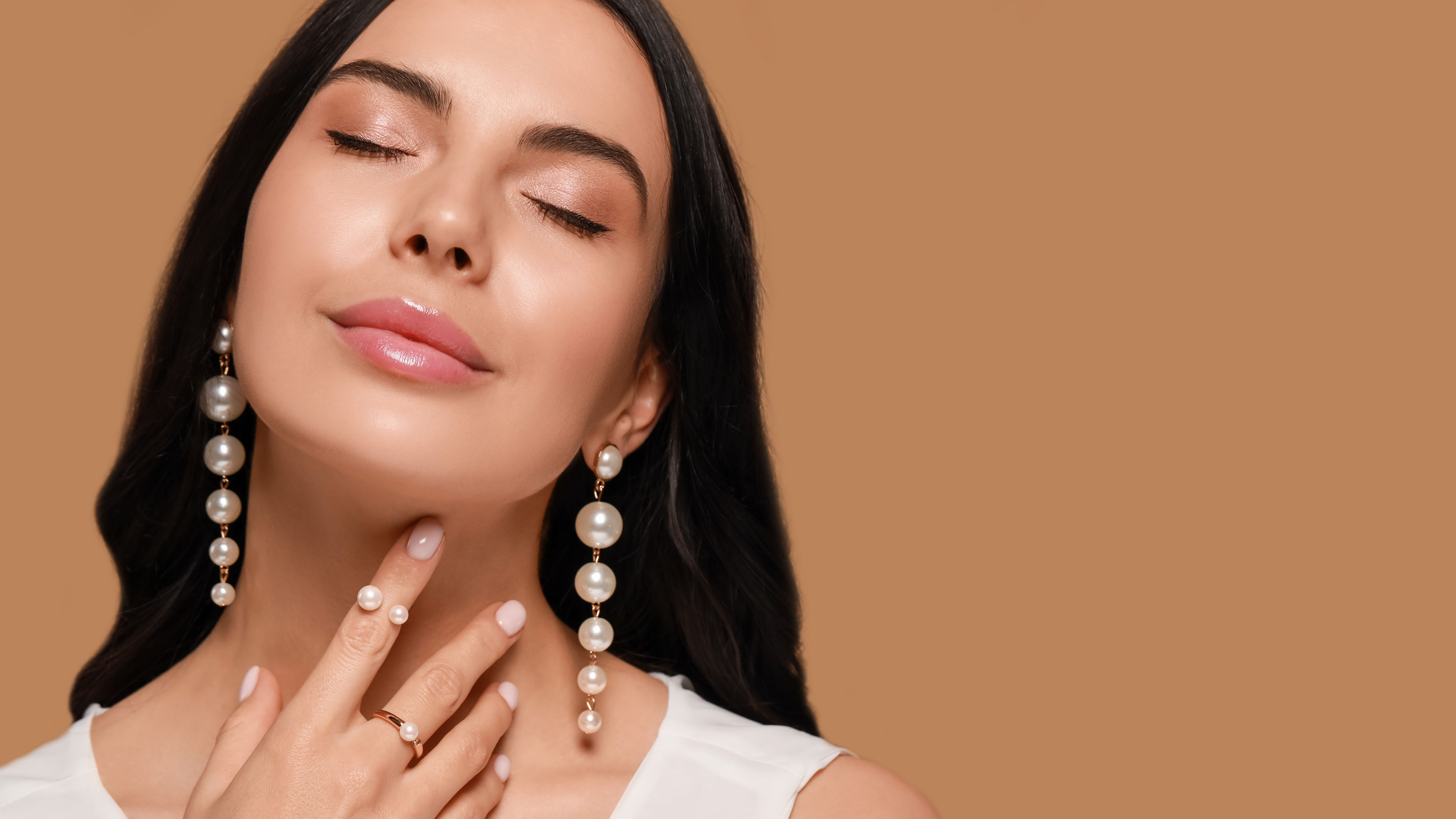 A woman with pearl earrings