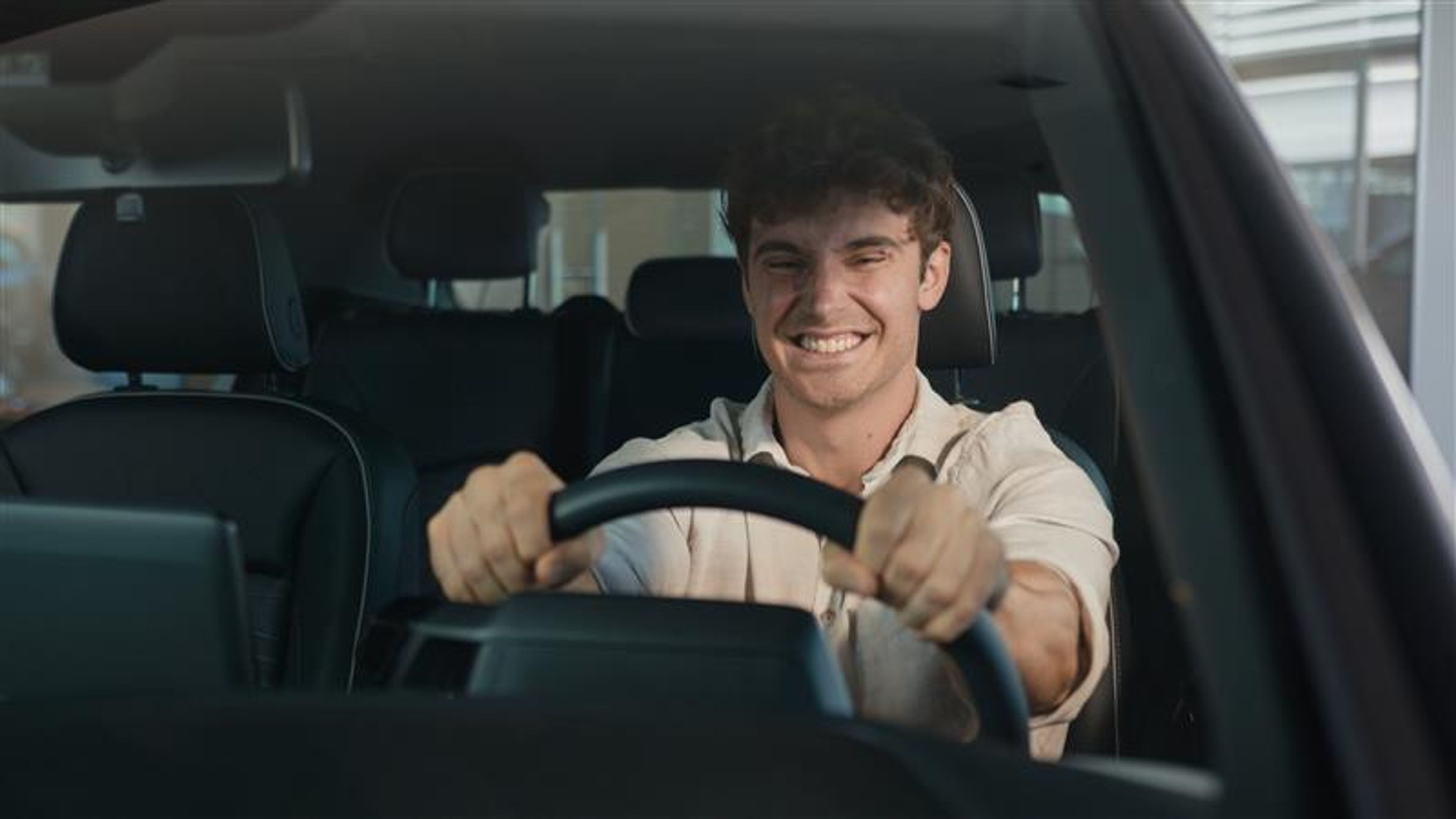 A young man driving a car