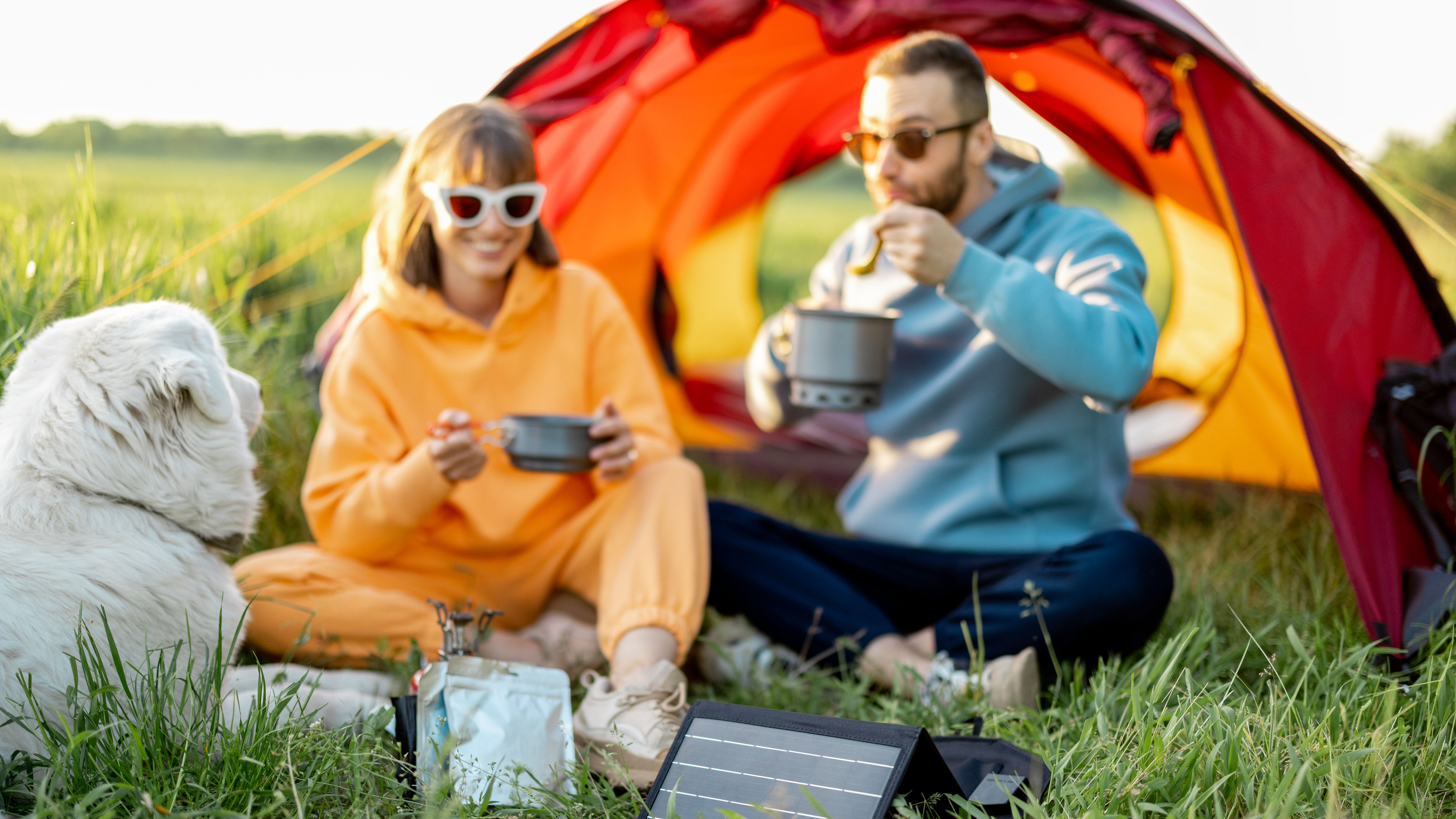 Couple and pet at campsite