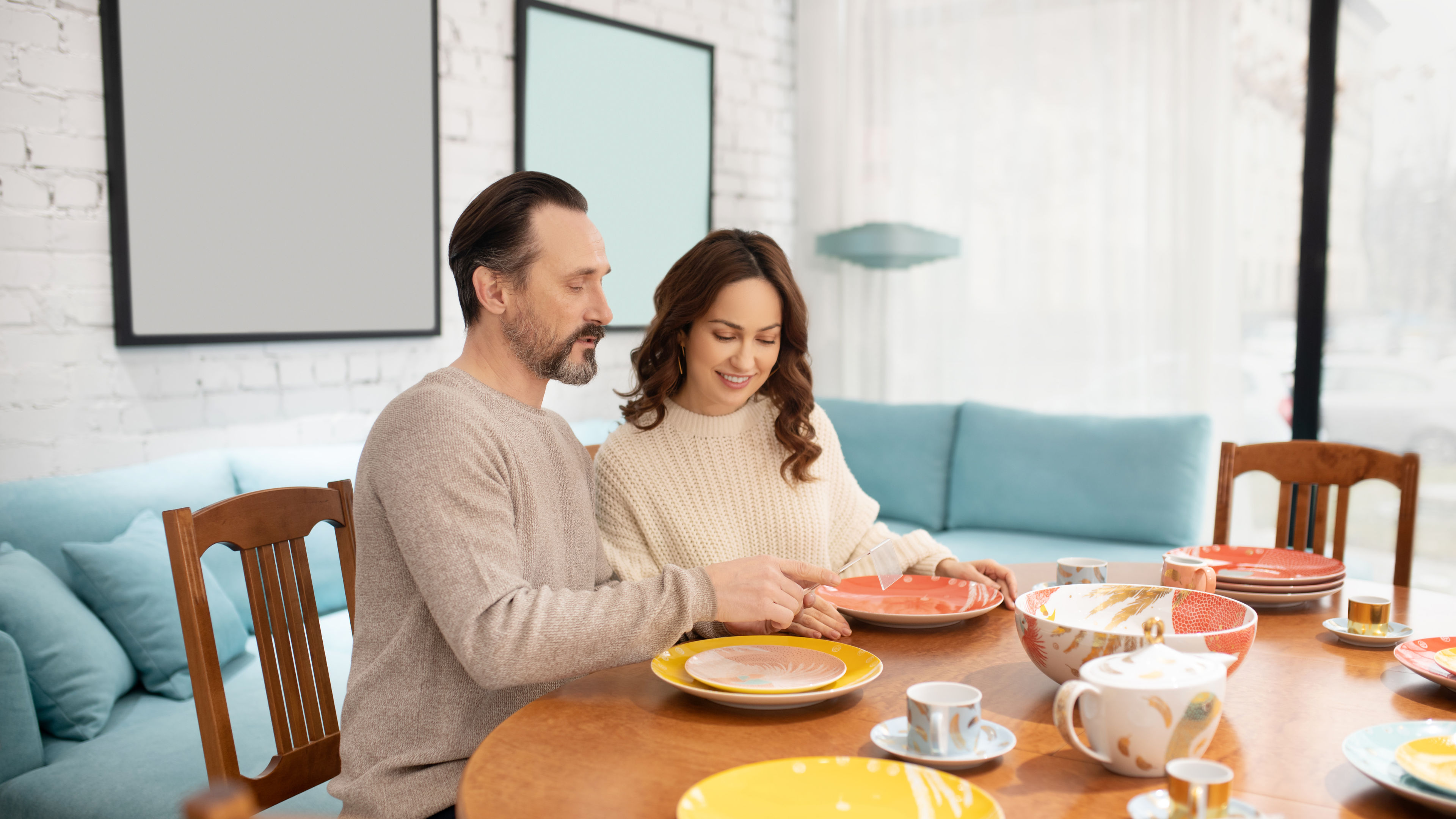 Couple Arranging Colorful Plates