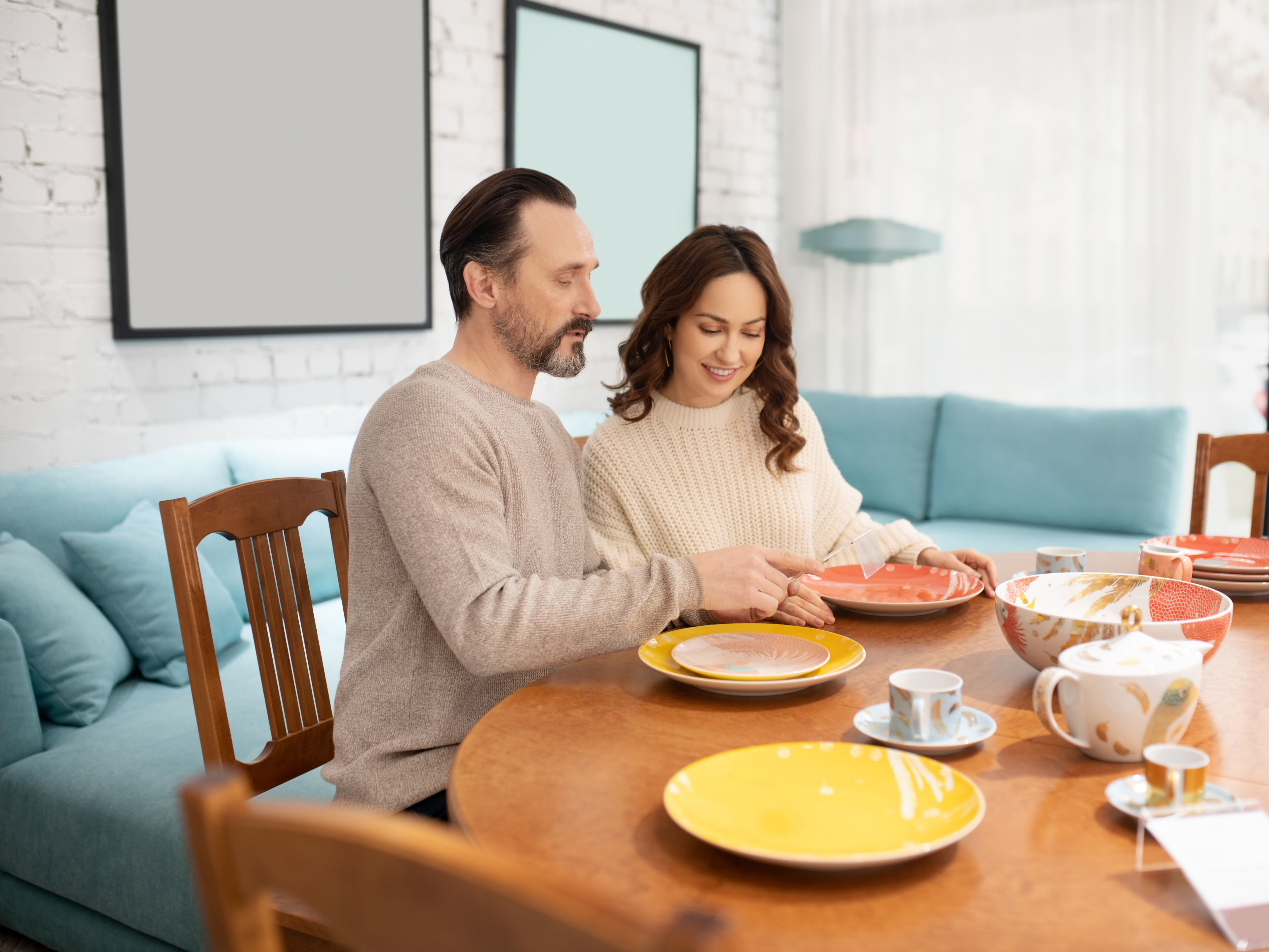 Couple Arranging Colorful Plates 
