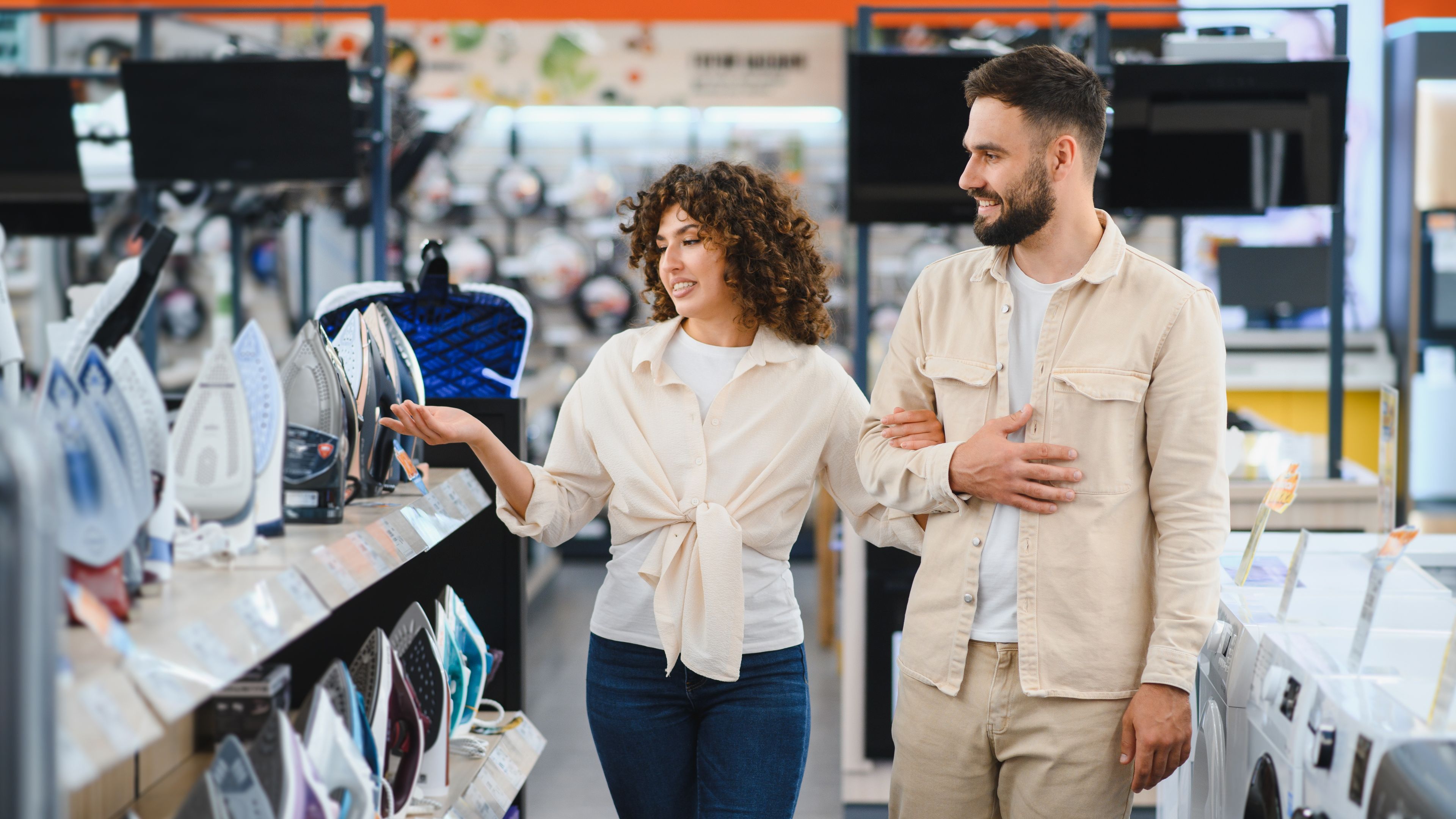 Couple exploring options in electronics store