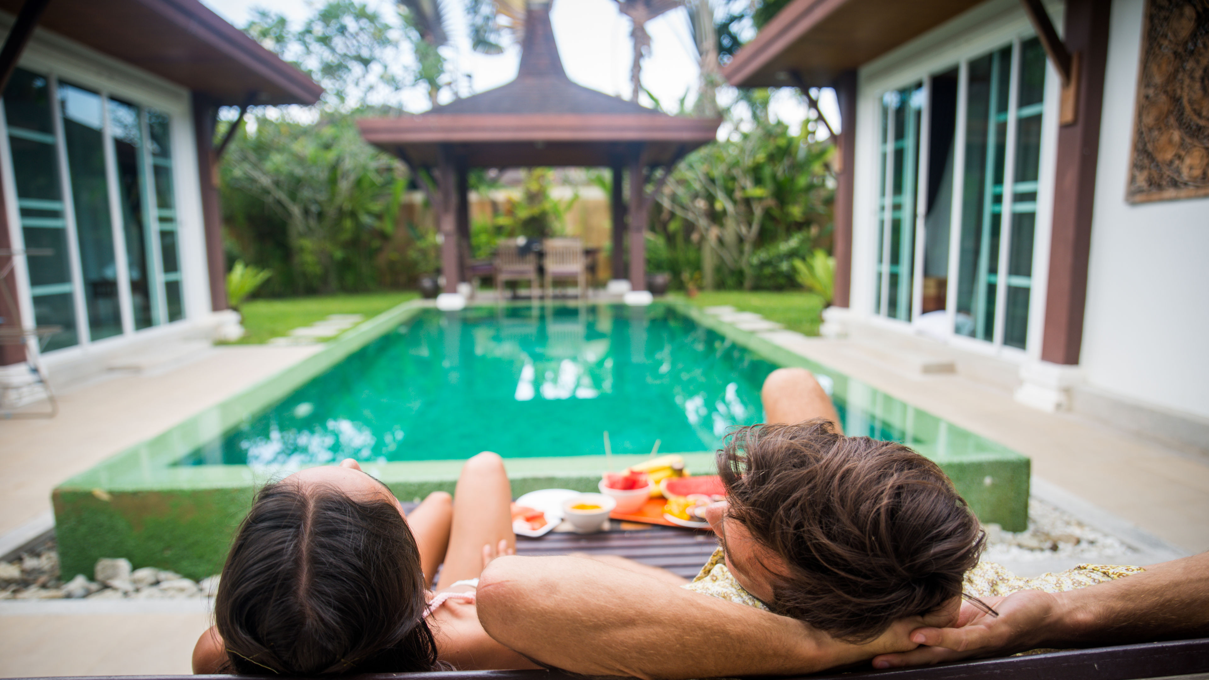 Couple of lovers in a beautiful villa with swimming pool