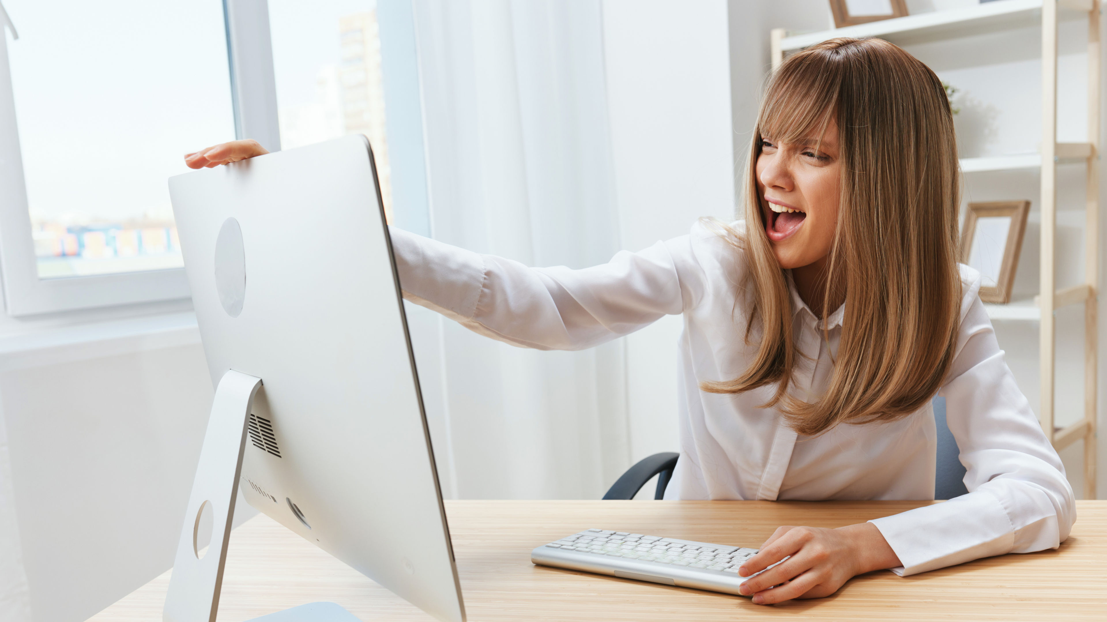 Excited Woman looking at her iMac 

 