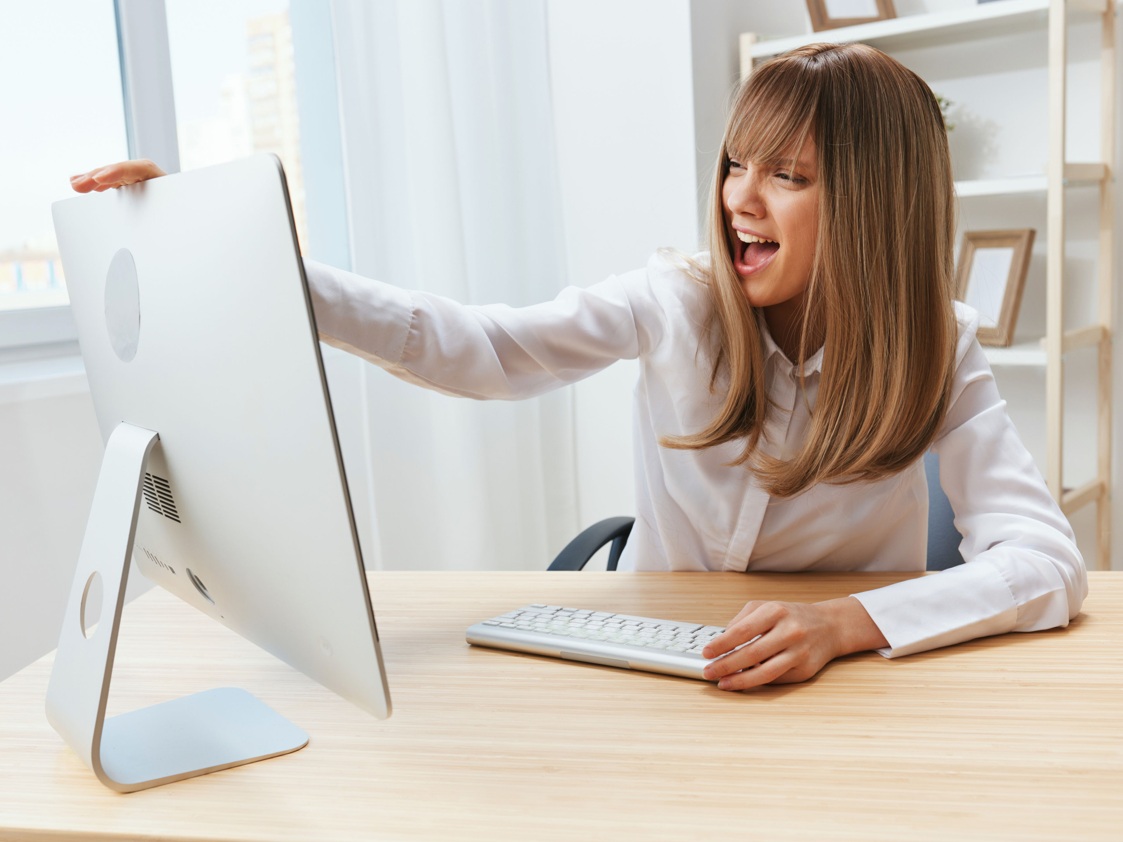 Excited Woman looking at her iMac 

