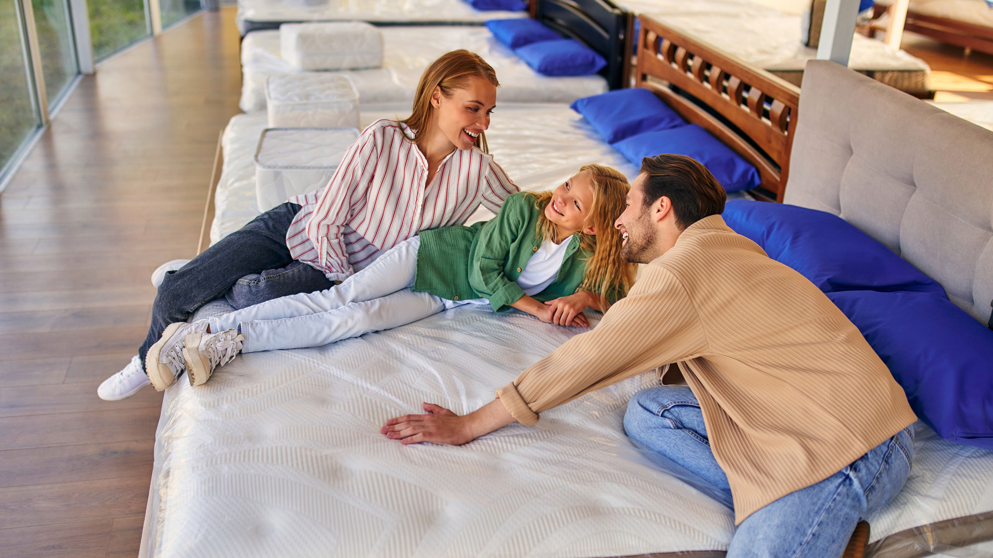 Family lying on mattress and smiling