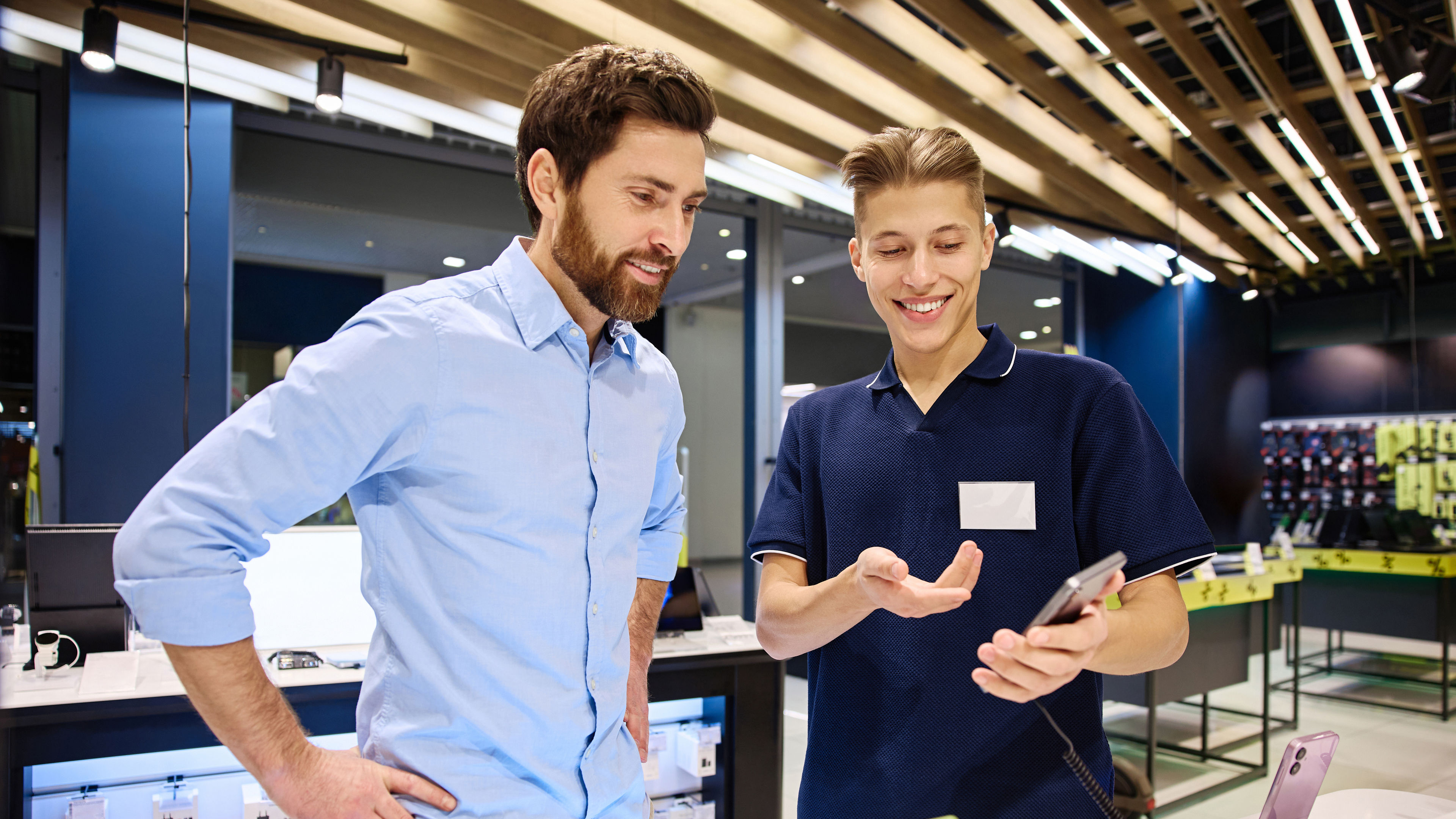 Friendly interaction occurs between a salesperson and Customer