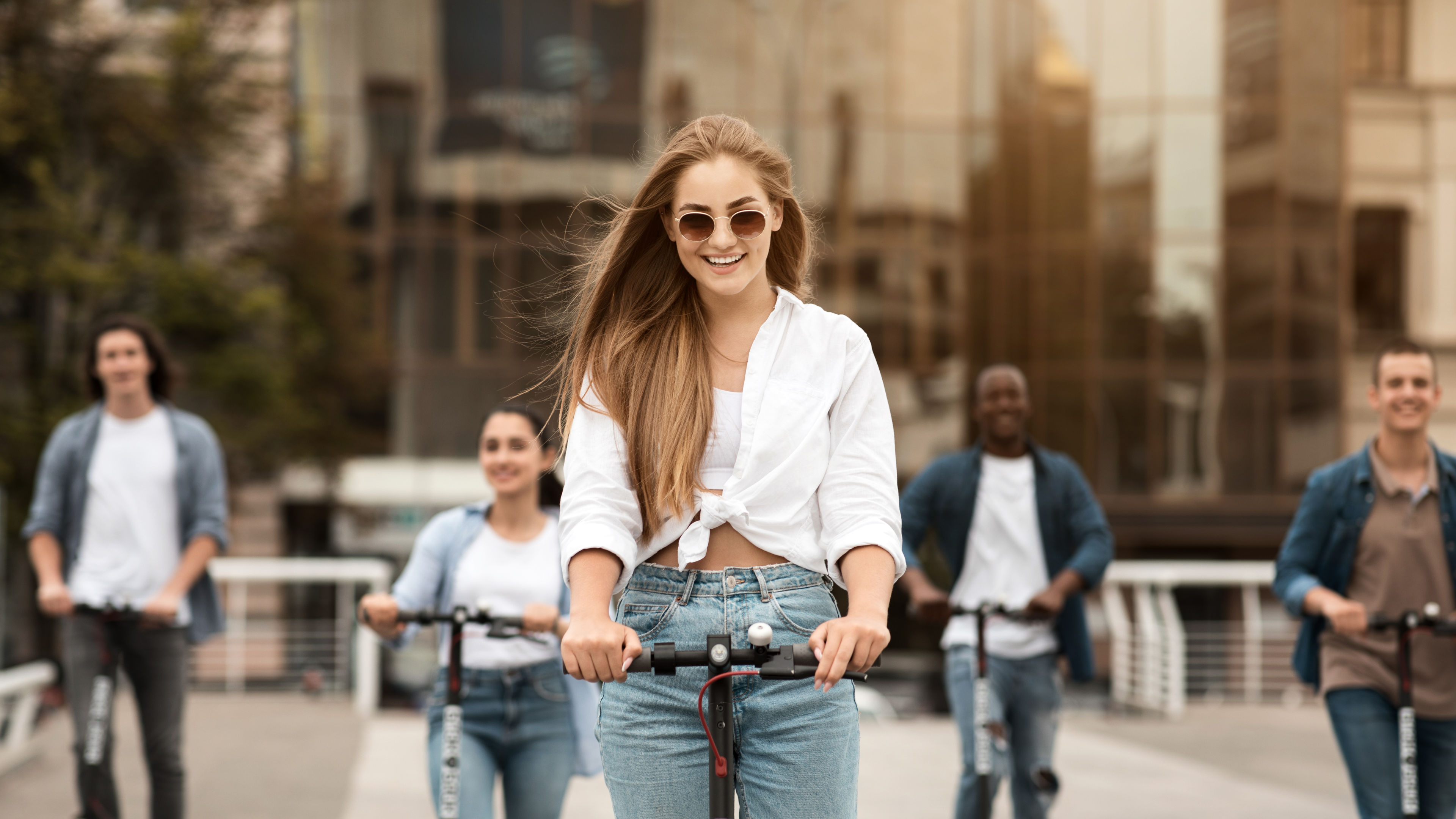 Friends Enjoying City Tour in E-Scooter