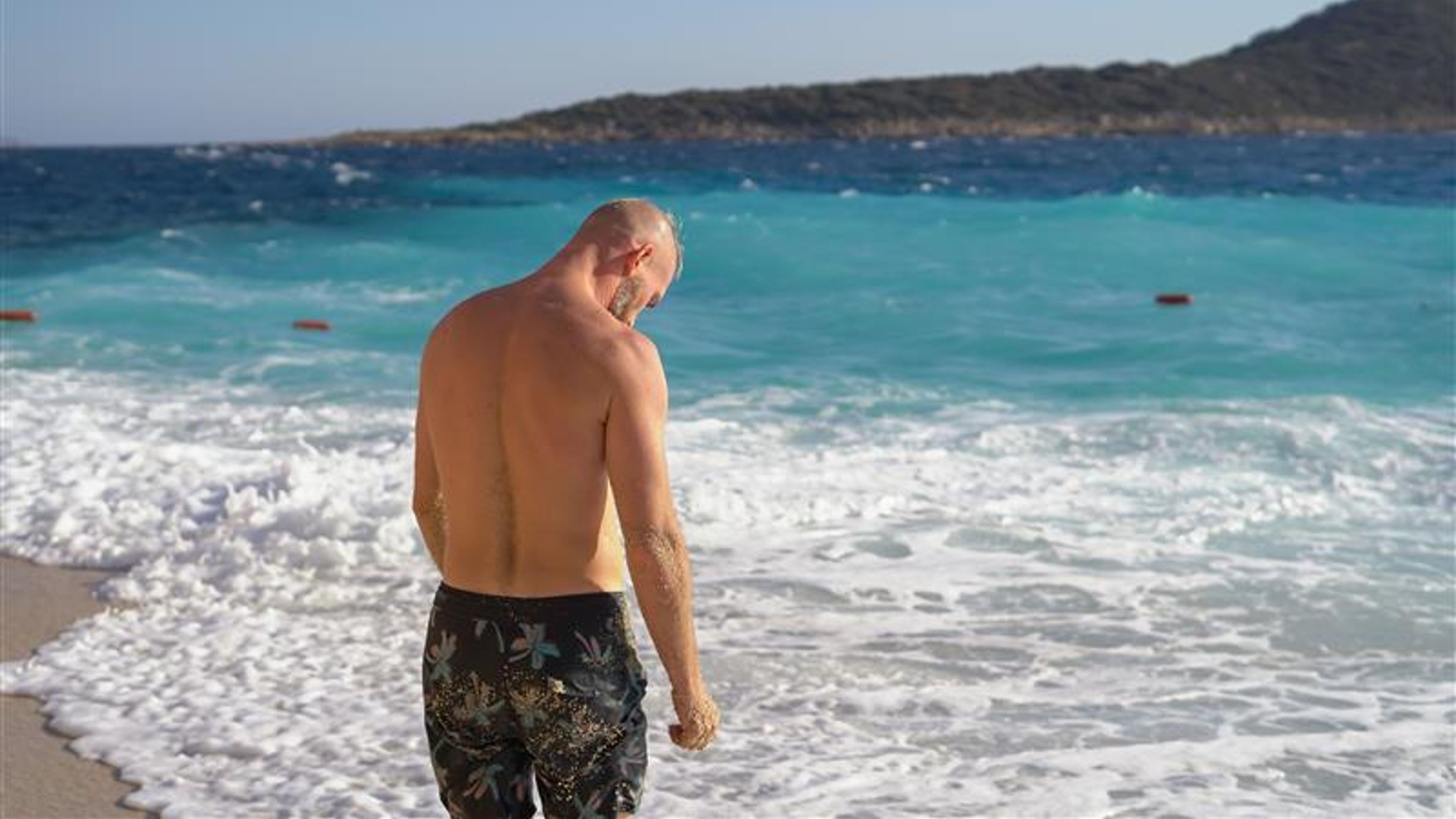 Man standing and facing the sea