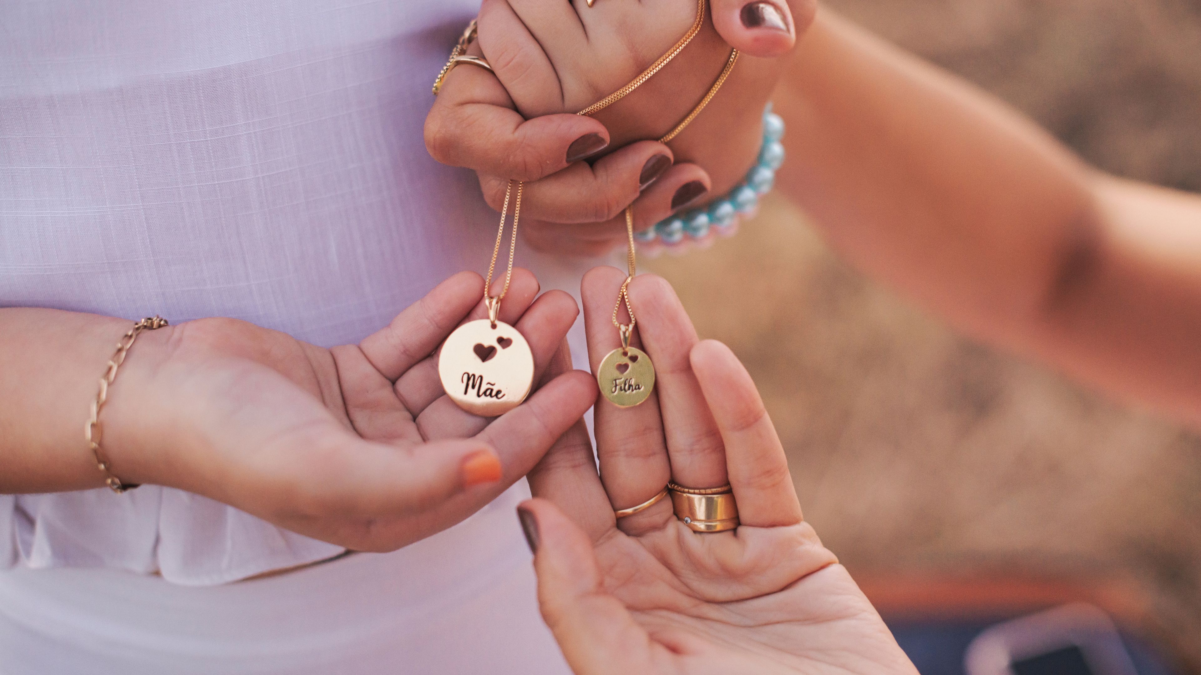 Mother and daughter holding necklace