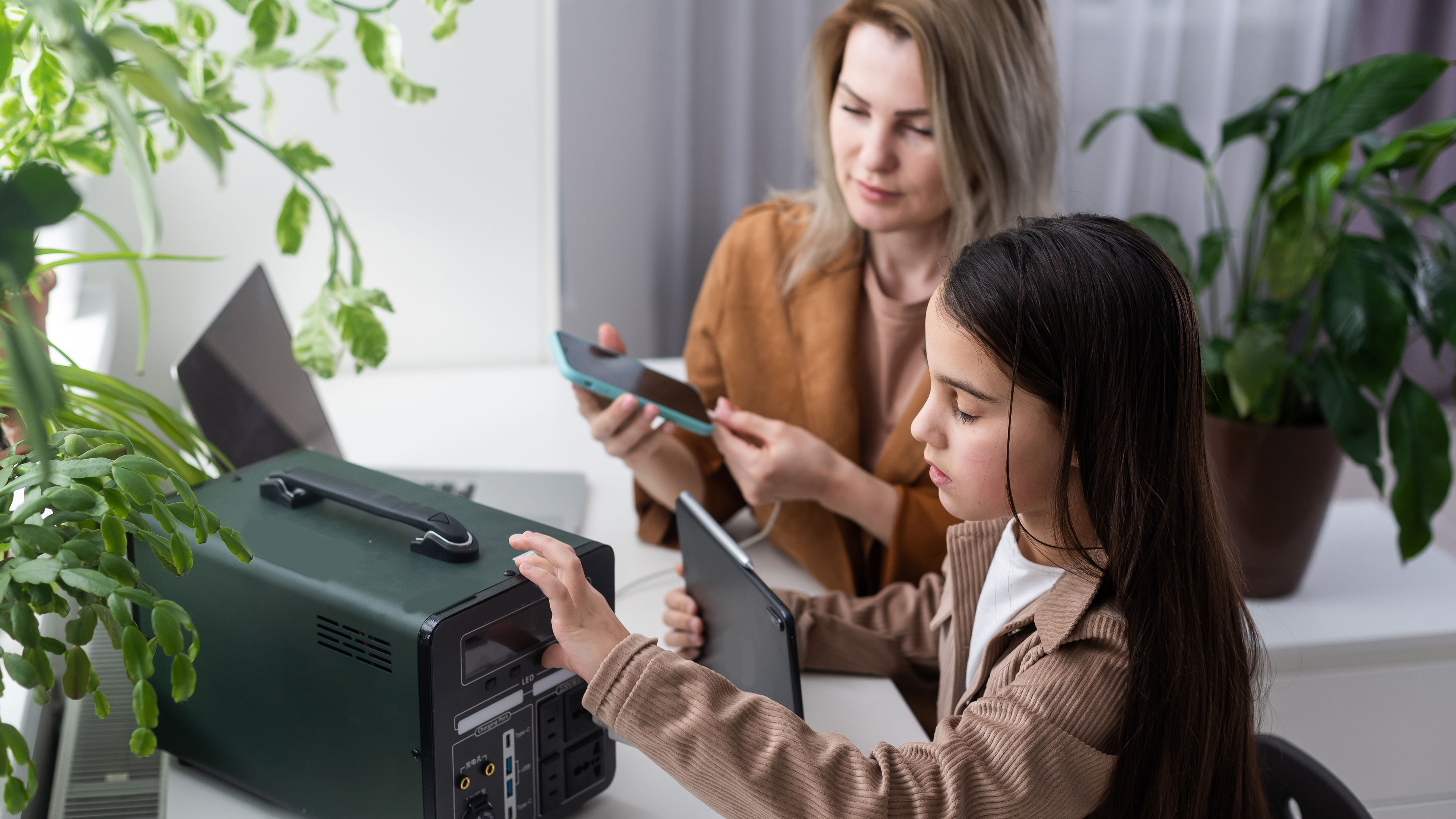 Mother and daughter using portable generator