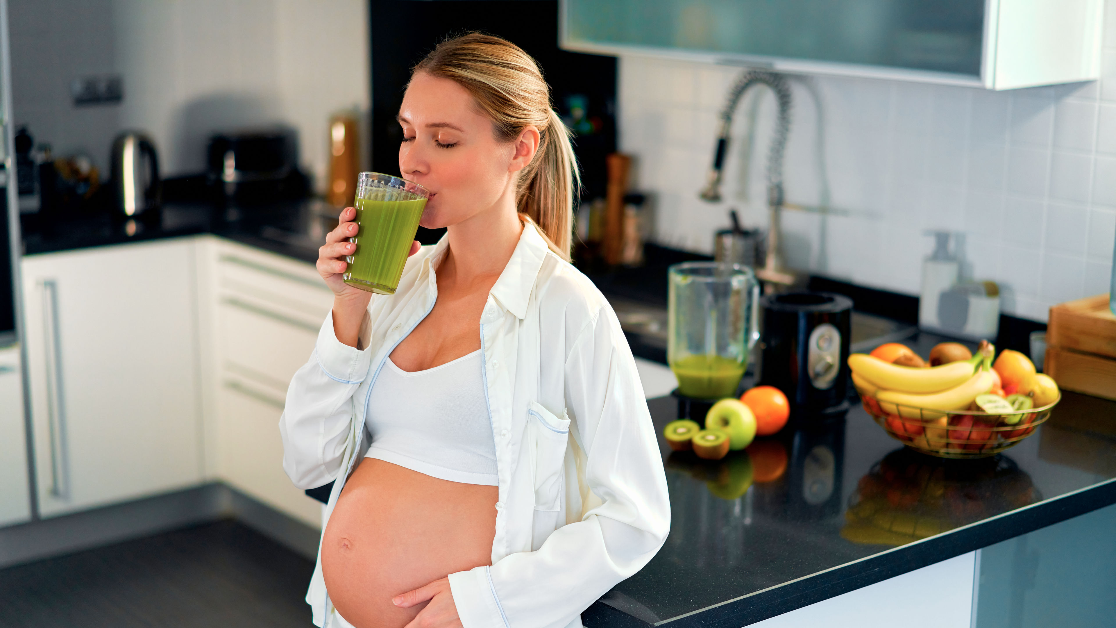 Pregnant woman drinking supplements