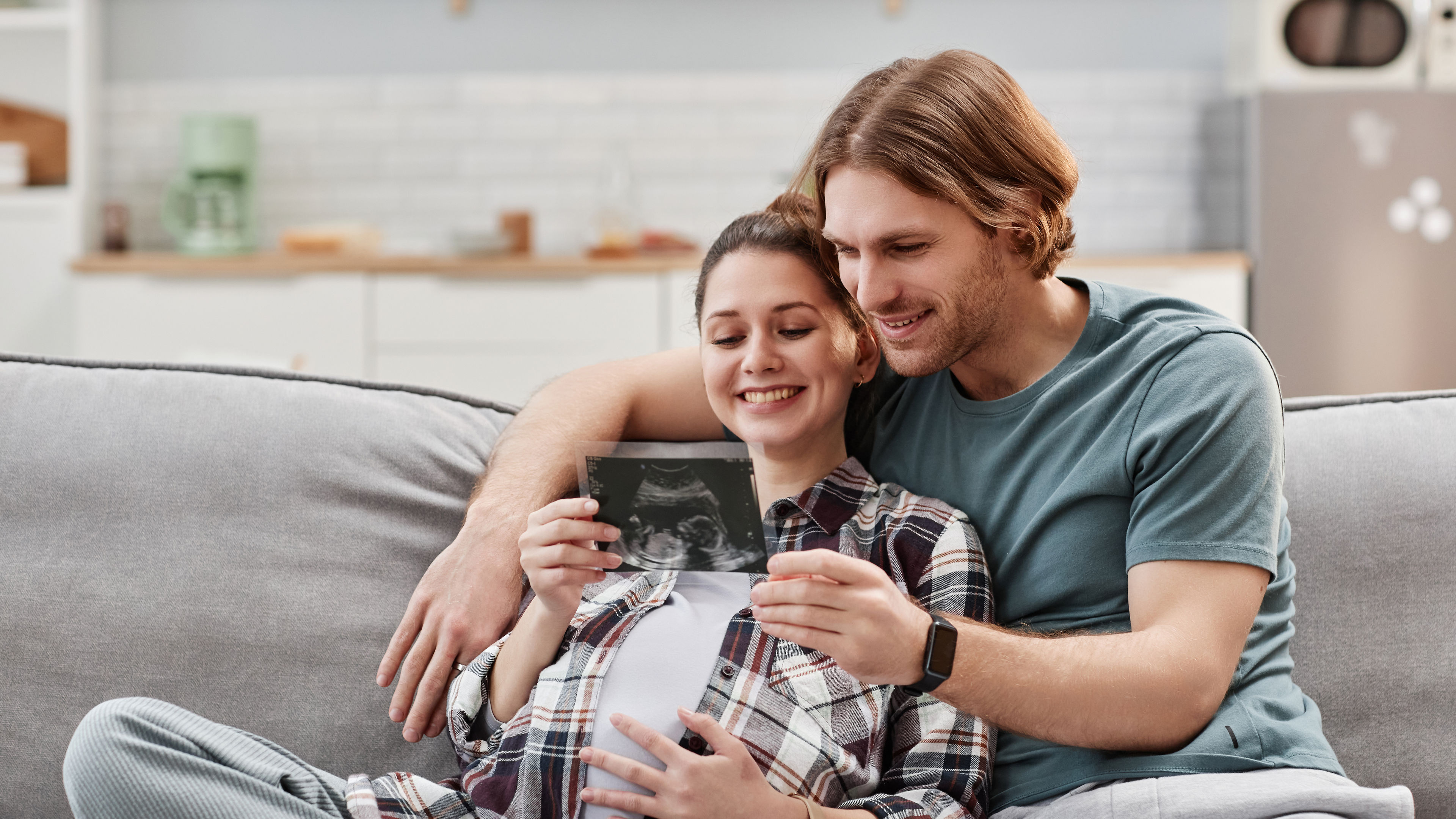 Smiling couple holding x ray image
