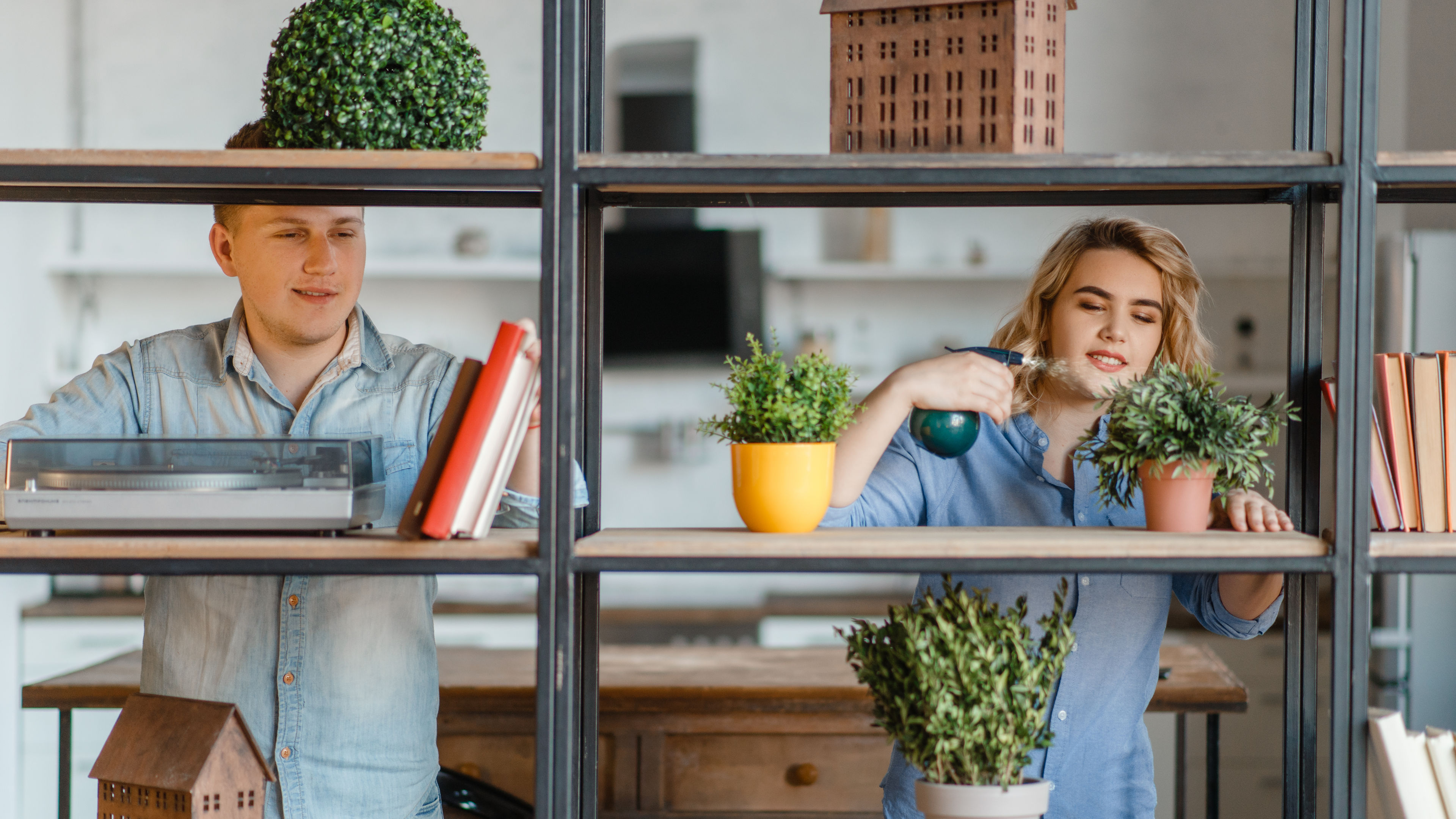 Smiling couple standing near shelf