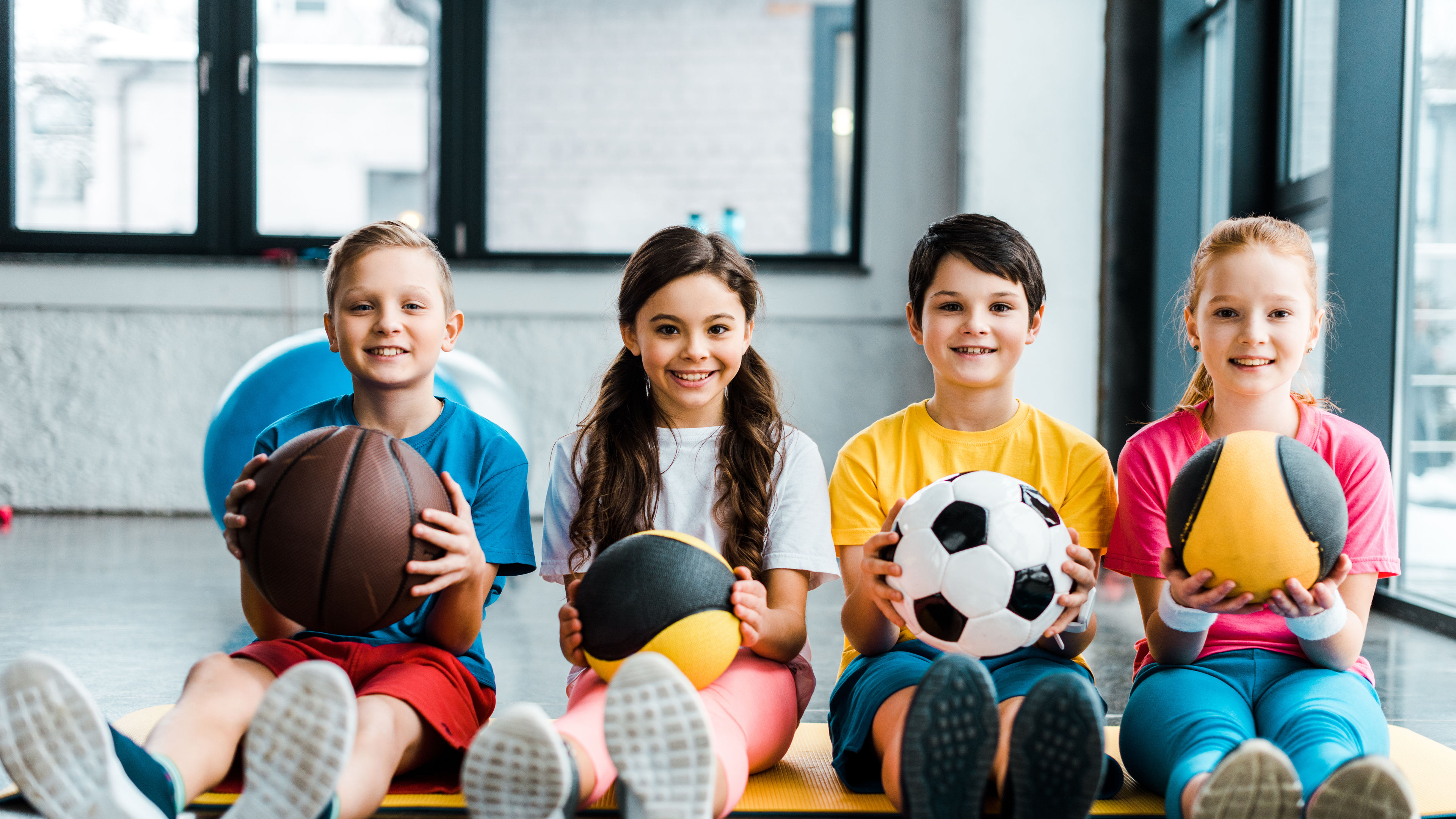 Some kids with balls in hand