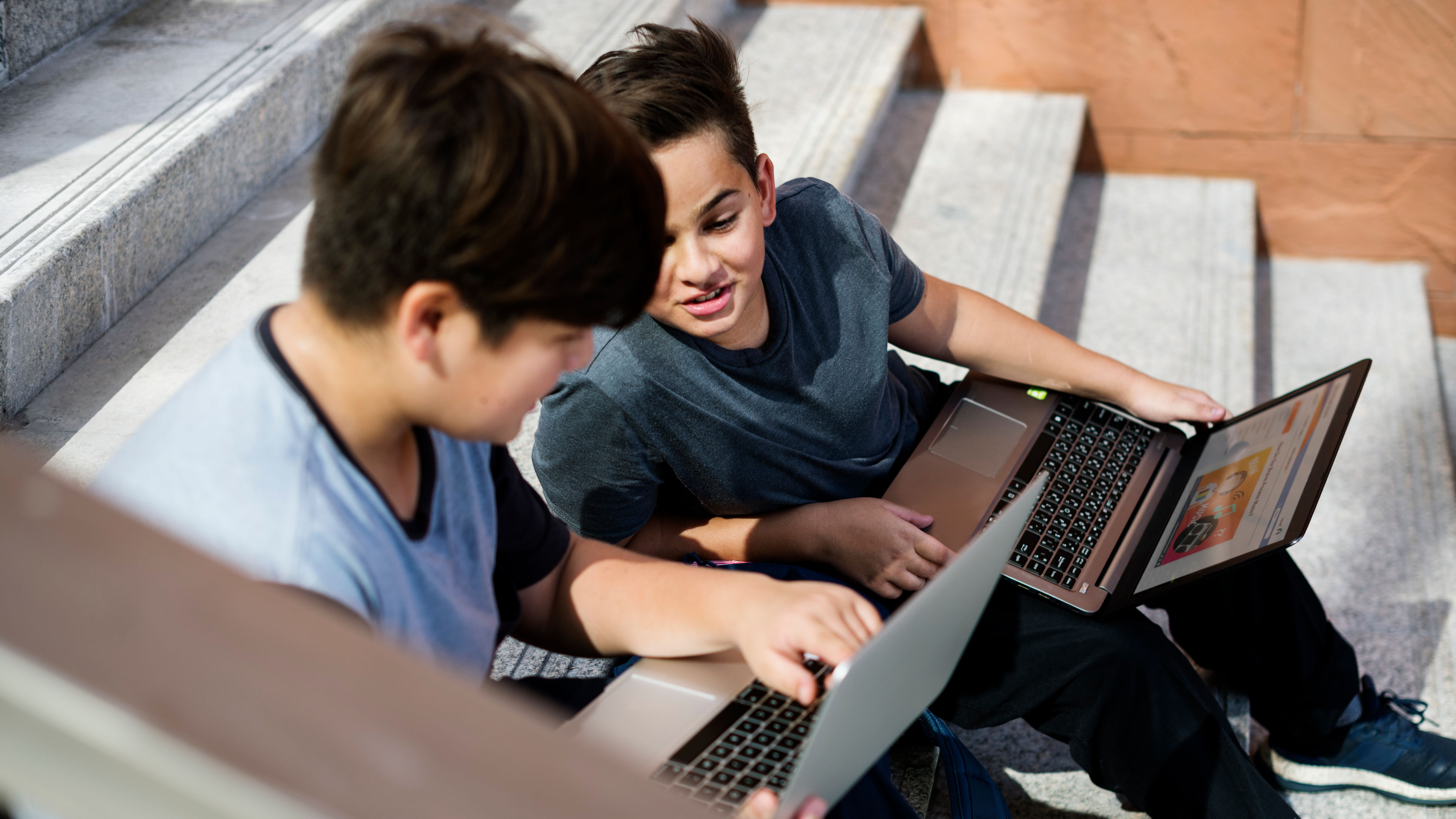 Teens using laptops