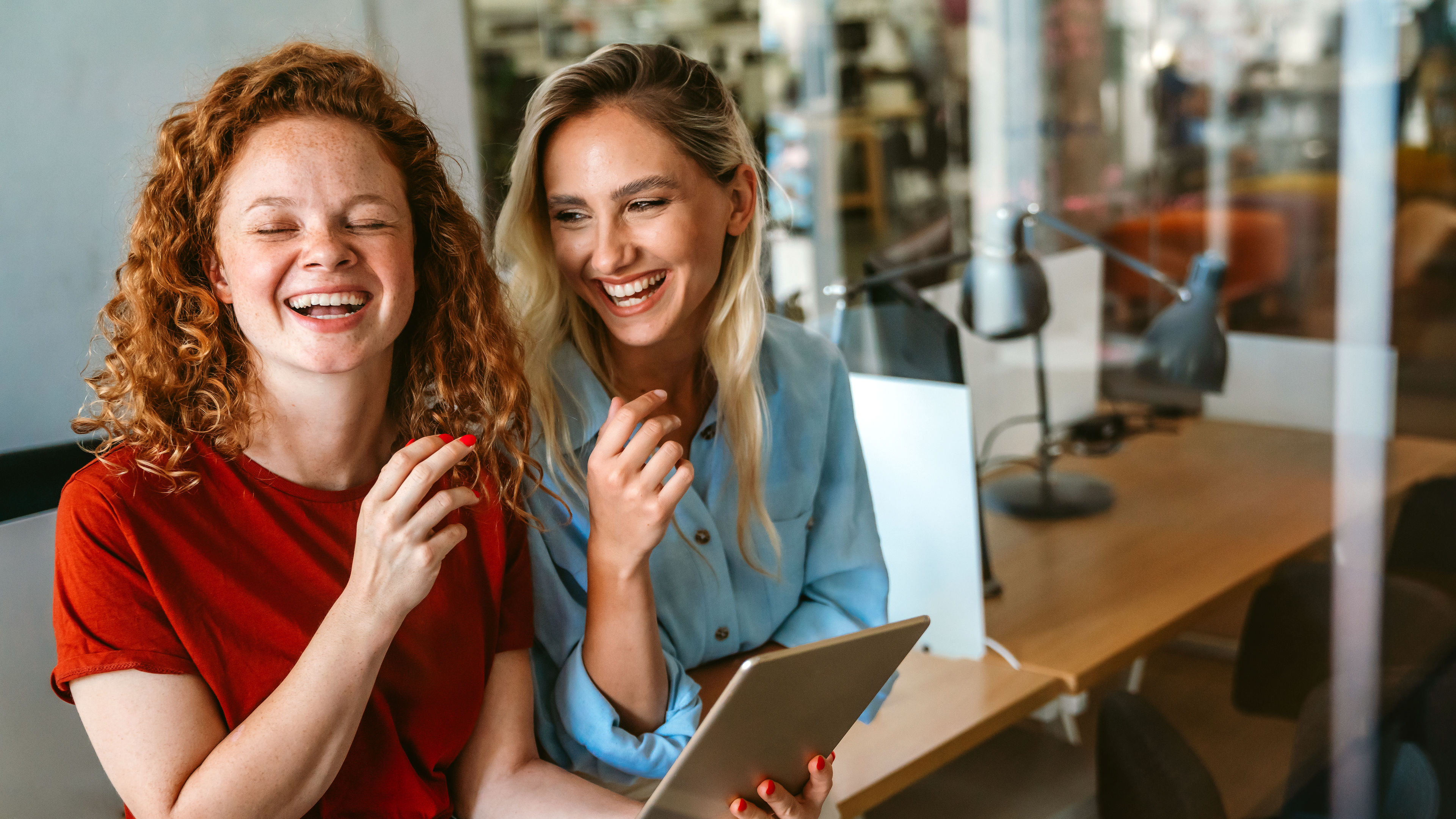 Two women working together on a tab 