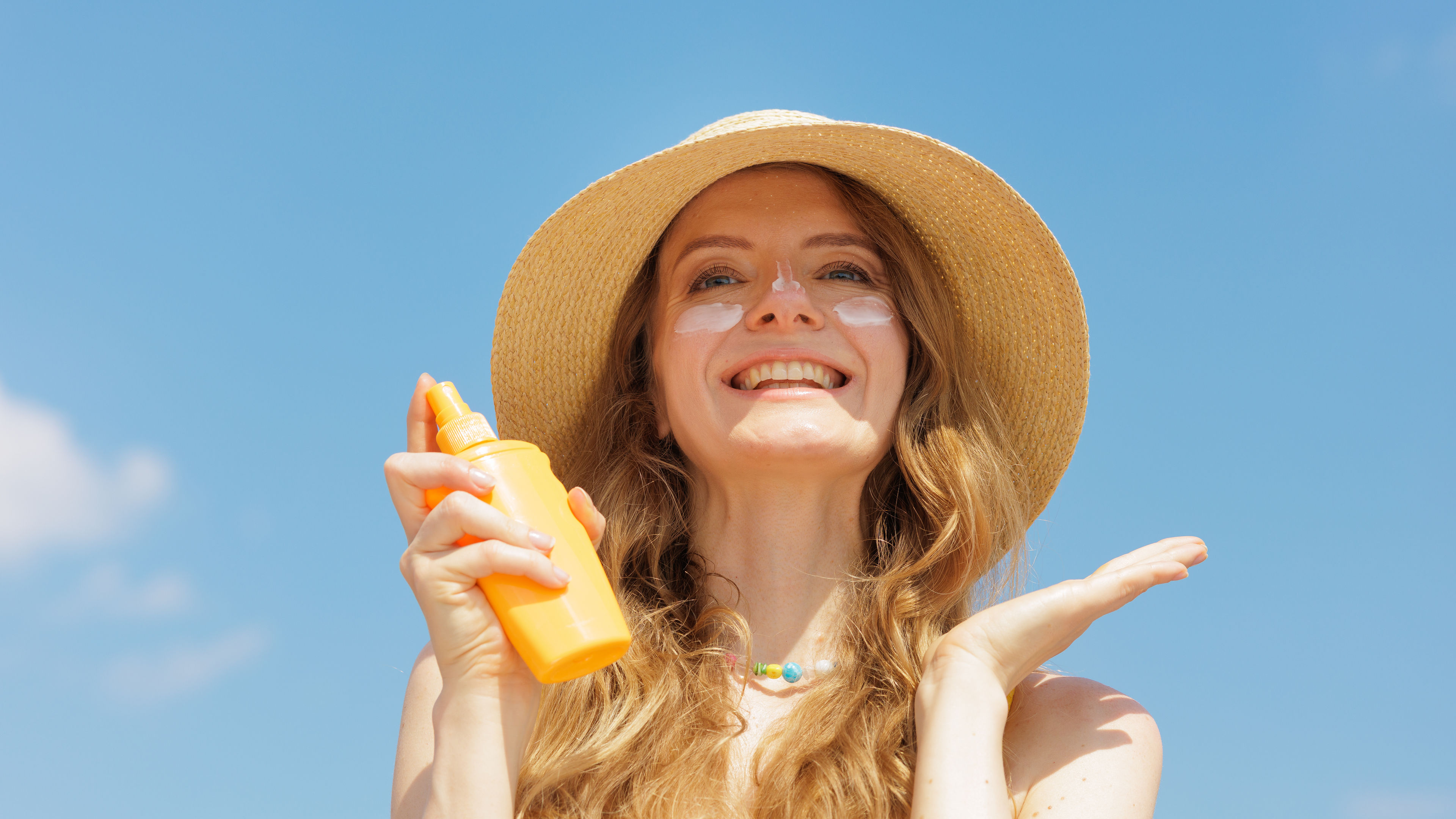 Woman applying sunscreen 