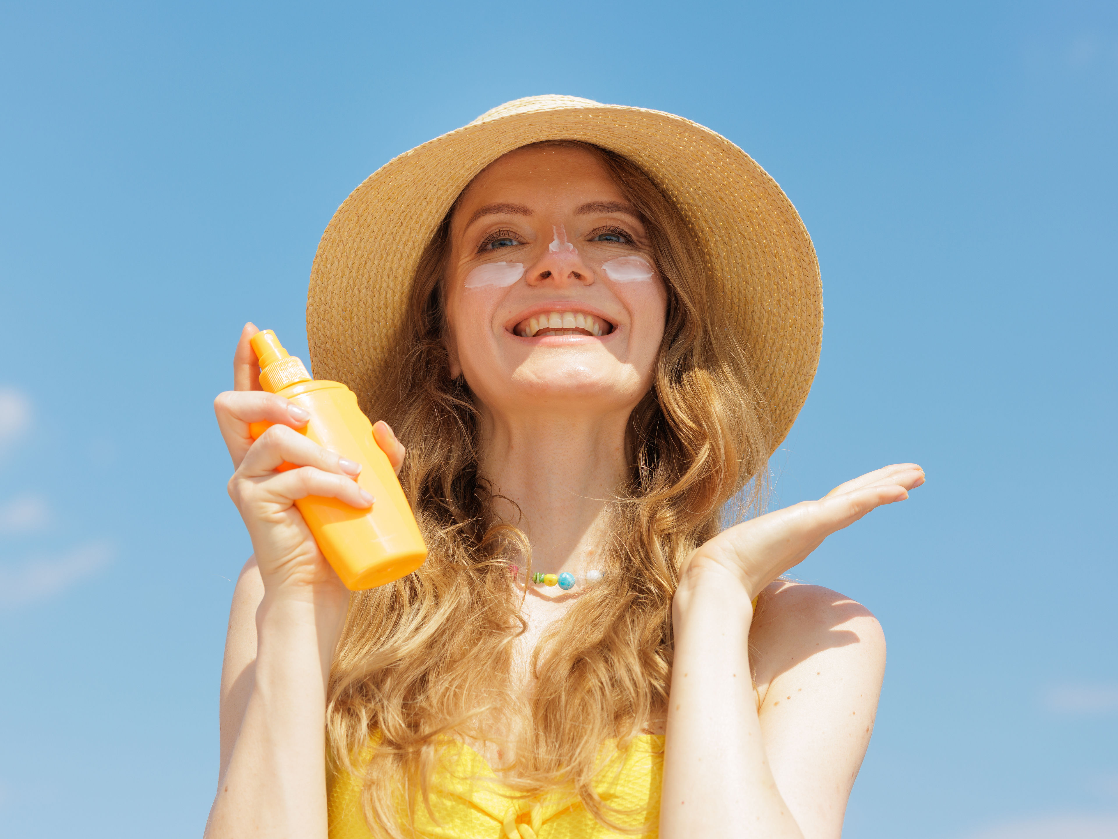 Woman applying sunscreen 