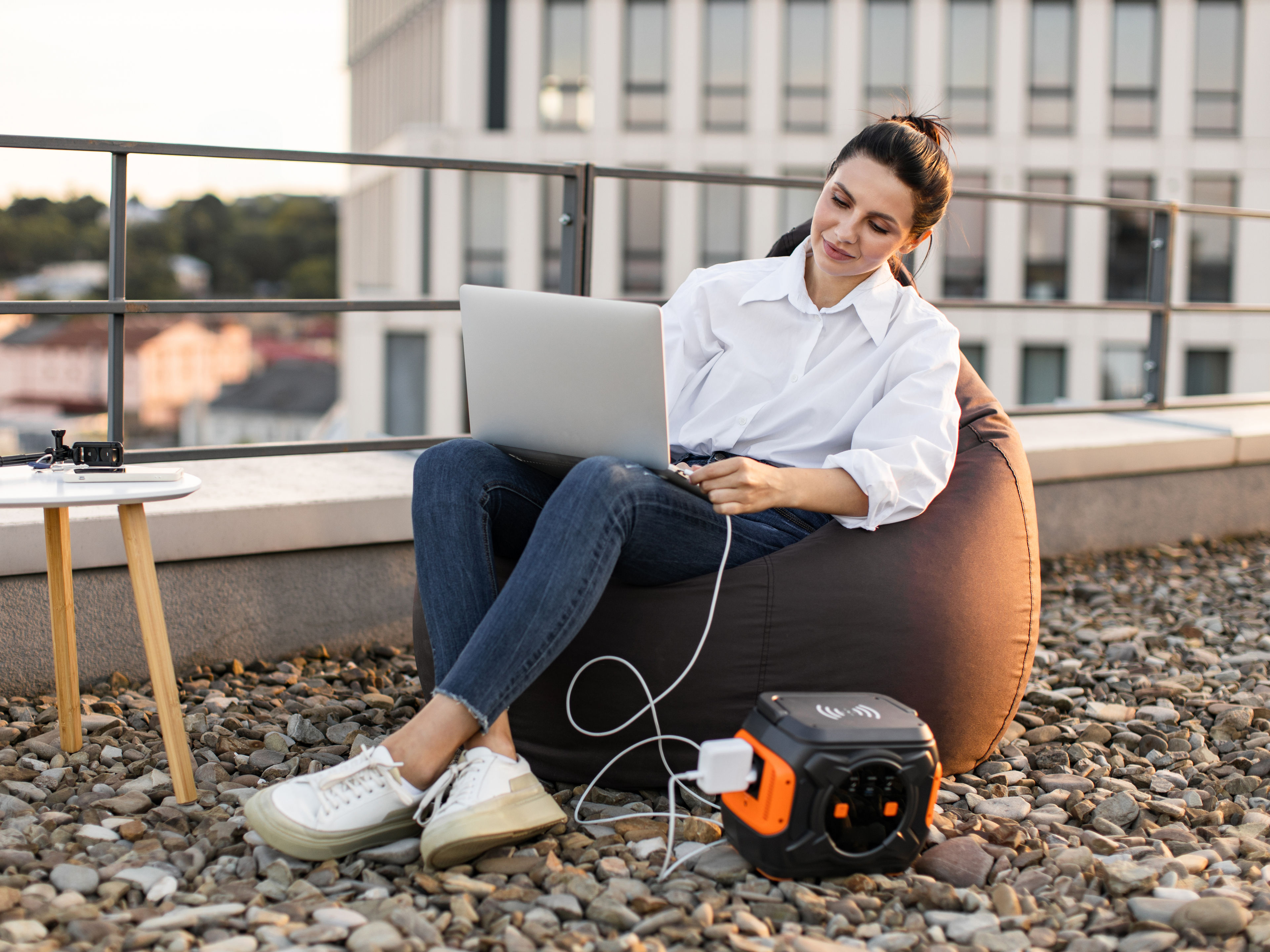 Woman charging laptop with portable power station