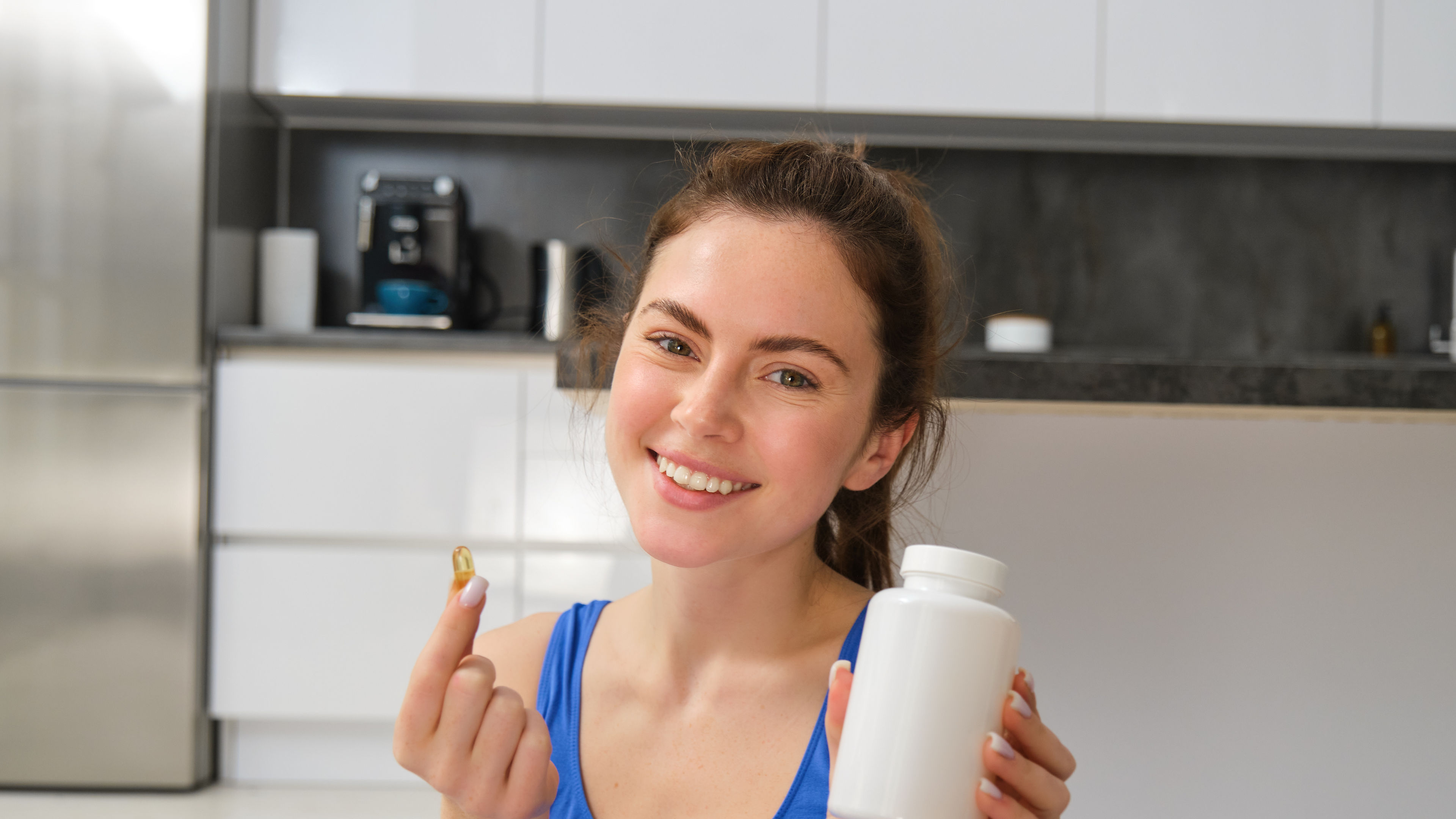 Woman holding a pill and supplement on her hand 