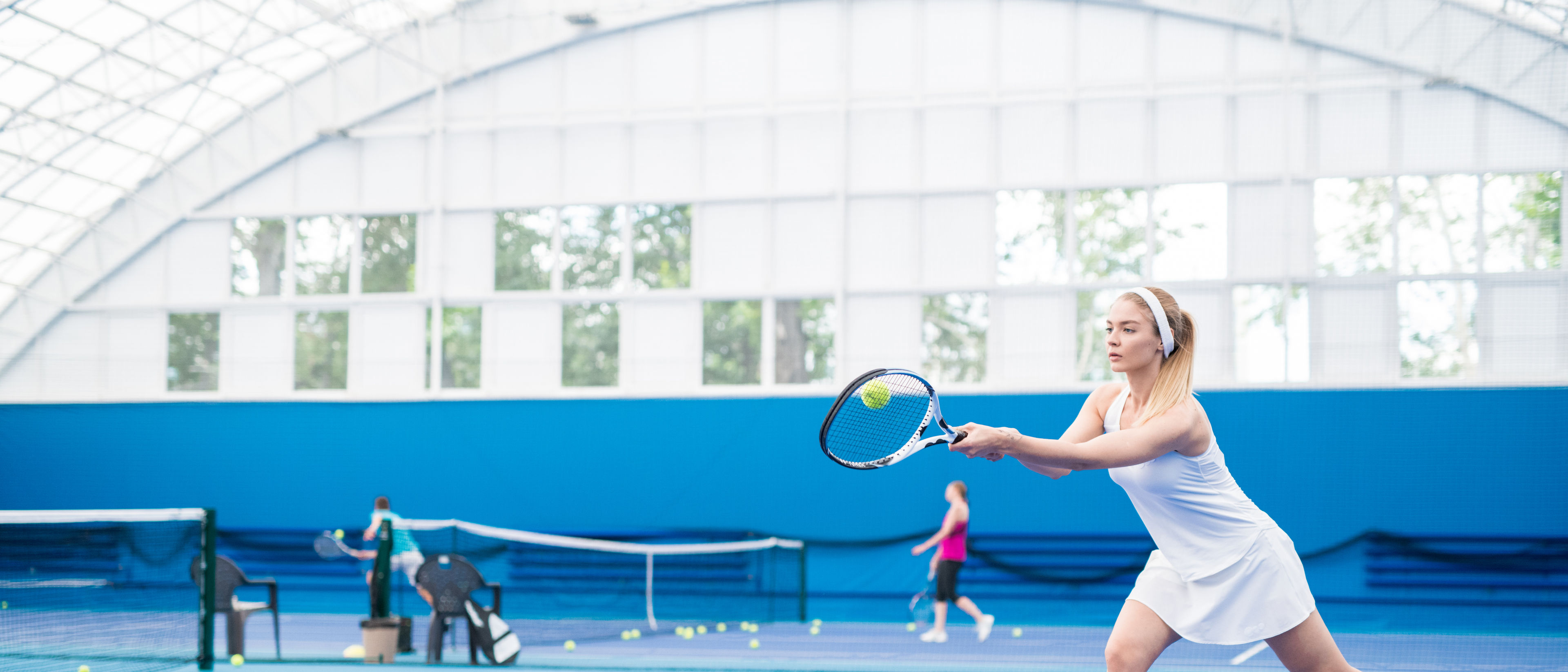 Woman playing tennis action shot