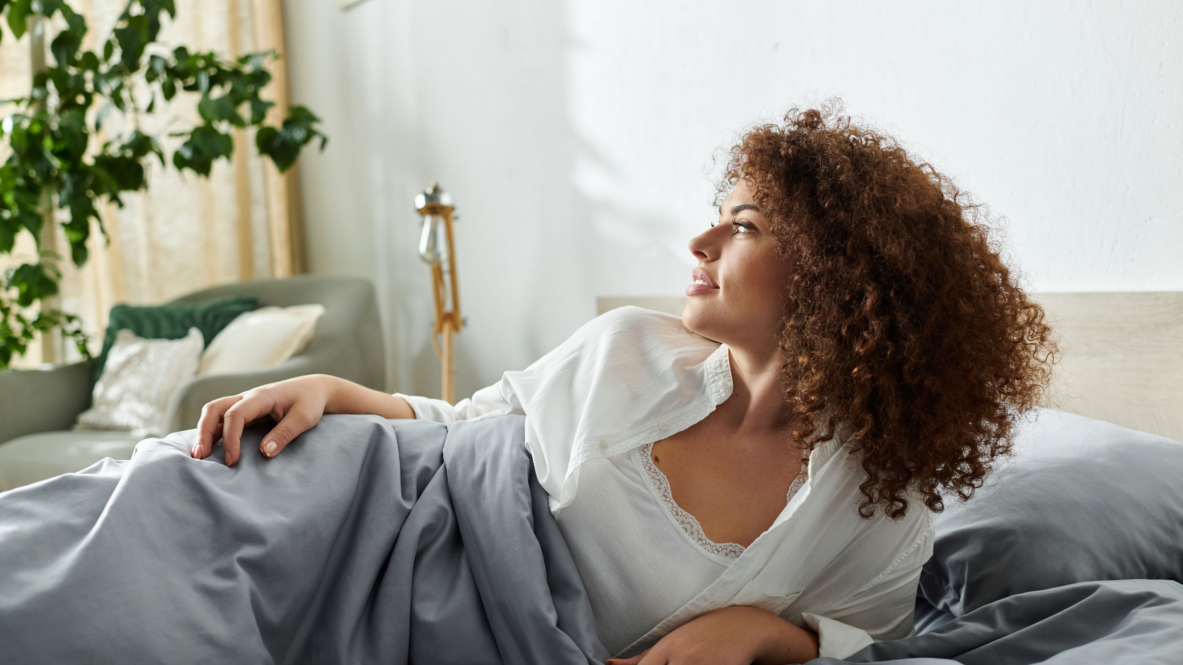 Woman Relaxing Peacefully in Bed