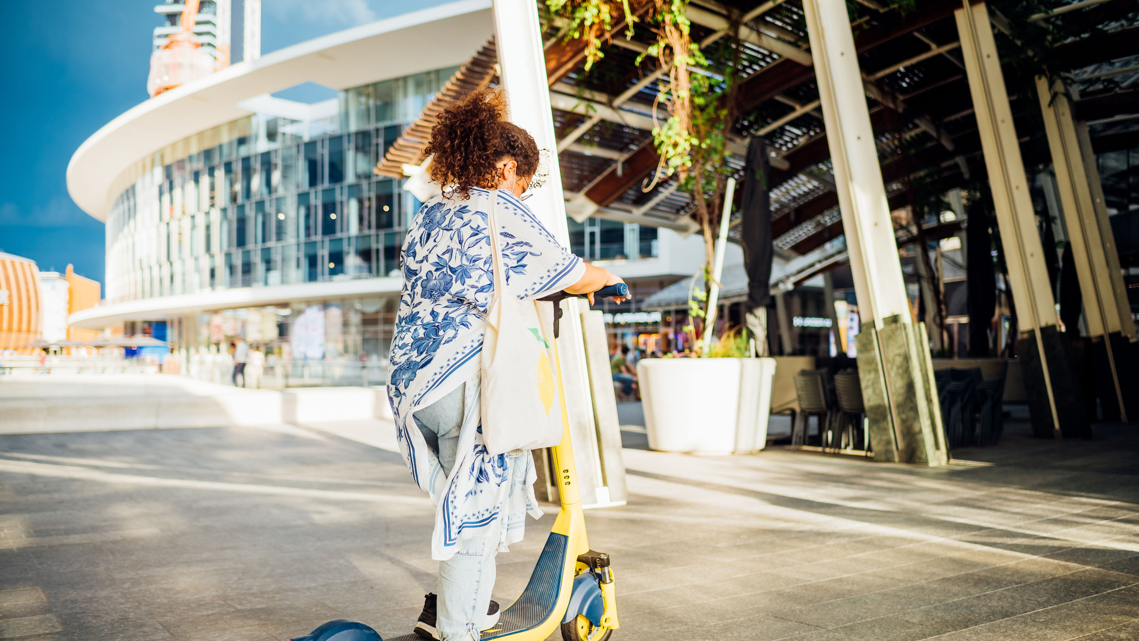 Woman riding electric scooter